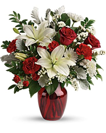 Visions Of Love Bouquet - A vision of love! This luxe bouquet of fragrant white lilies and radiant red roses, hand-delivered in a ruby vase, is the perfect expression of your feelings. This beloved bouquet includes red roses, white asiatic lilies, red carnations, red miniature carnations, white cushion spray roses, white sinuata statice, dusty miller, huckleberry, and lemon leaf. Delivered in a ruby rose vase.