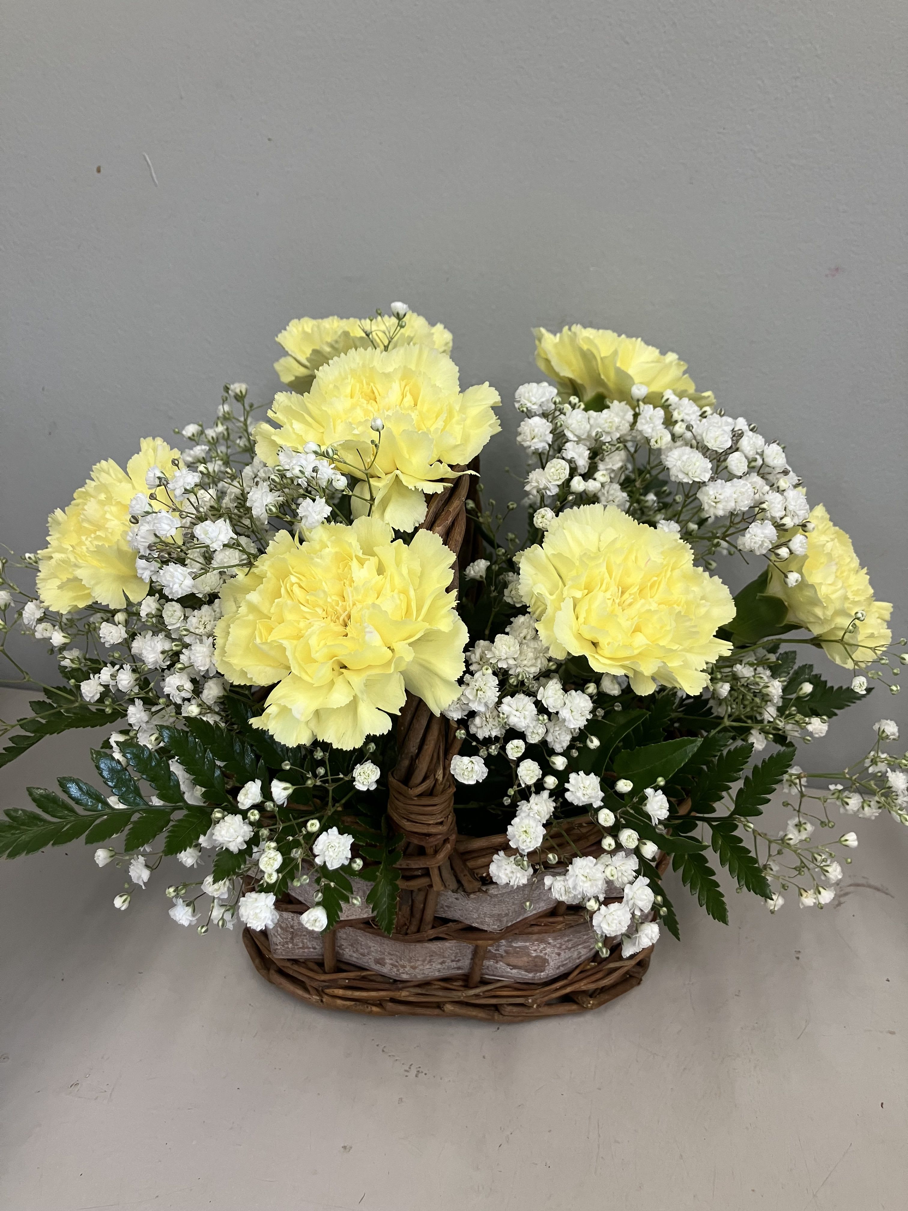 Sweetest Memories Sweetest Memories - A sweet and simple basket of soft yellow carnations and flowing baby’s breath.