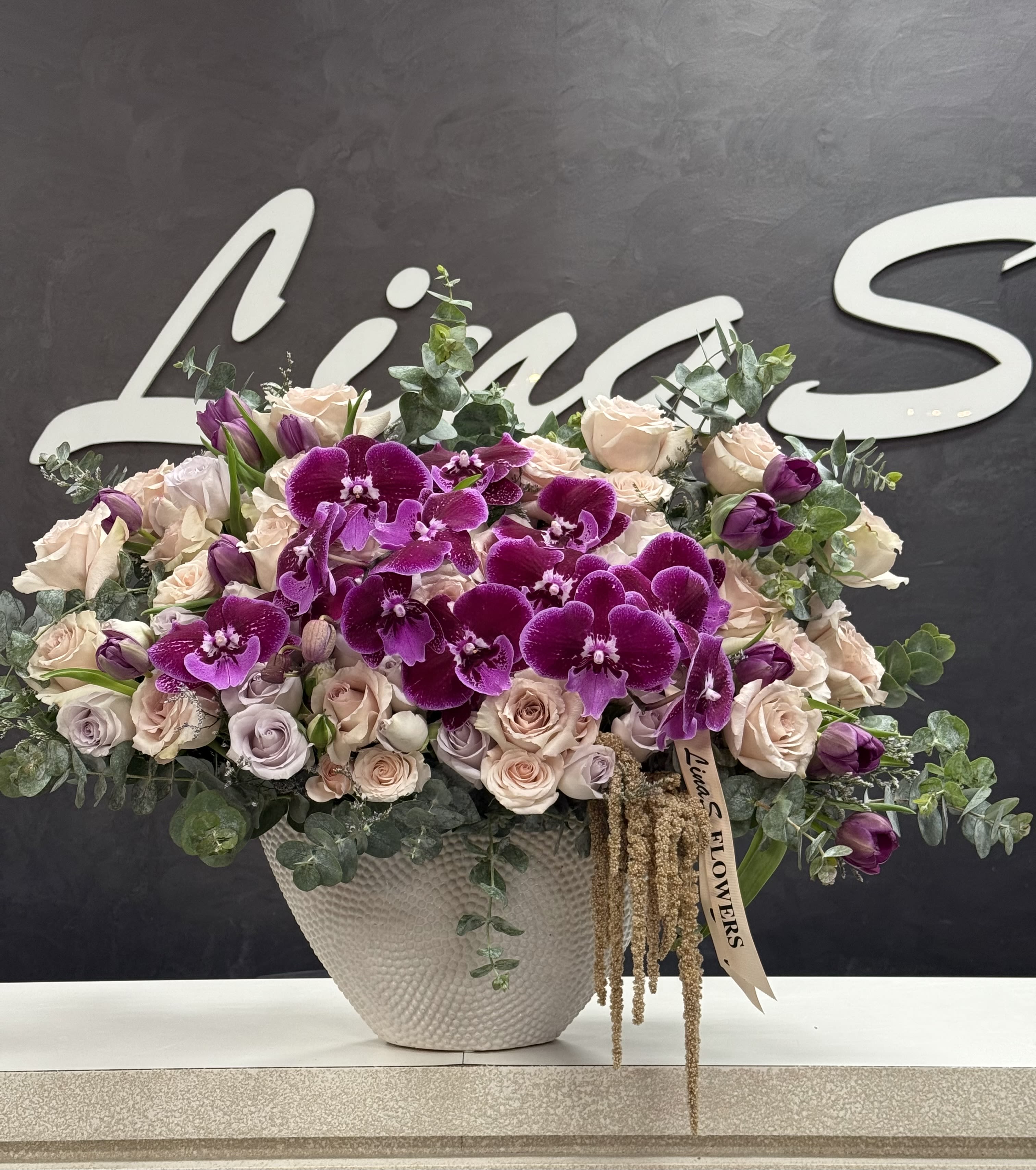 Purple Phalaenopsis Purple Phalaenopsis - A stunning purple Phalaenopsis arrangement — elegant, luxurious, and beautifully captivating.