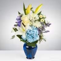 Happy Serene Happy Serene - This elegant, peaceful floral arrangement is a stunning way to express your respects or offer condolences. It combines a harmonious blend of roses, Asiatic lilies, chrysanthemums, hydrangeas, and carnations, complemented by other seasonal blooms to create a beautiful and heartfelt display. Seasonal Blooms: The inclusion of seasonal flowers ensures the arrangement is fresh, vibrant, and timely. Dimensions Approximate Size: 14 inches in diameter and 24 inches in height