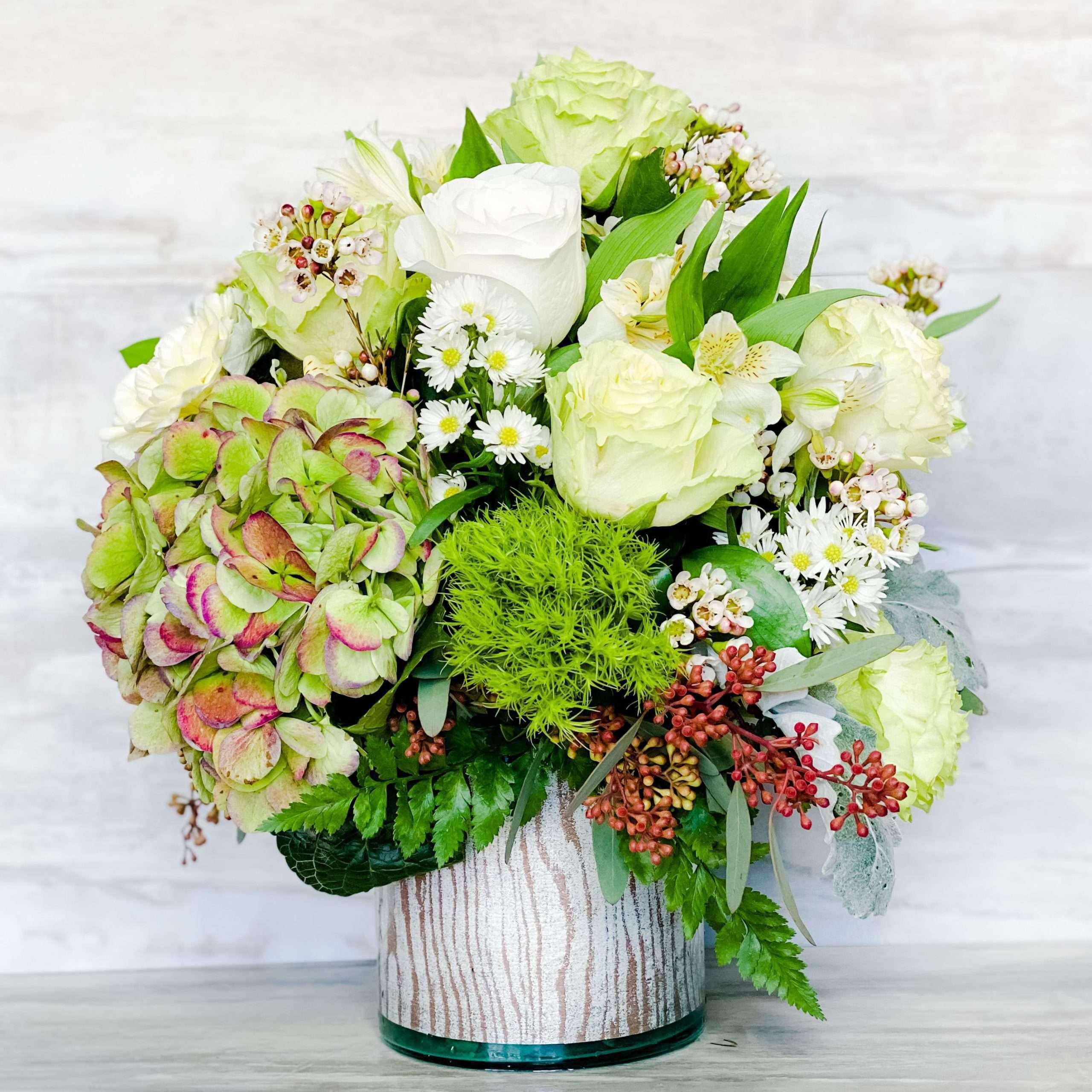 Seaside Roses Bouquet By DGM Flowers Seaside Roses Bouquet By DGM Flowers - Reminiscent of a seaside garden, this gorgeous bouquet of green and white roses, green hydrangeas Dianthus is beautifully presented in a glass cylinder vase . Stand out with this green flowers bouquet that is sure to captivate and impress. Add a touch of beauty and sophistication to any occasion with this exquisite bouquet. White roses, white alstroemeria, green roses and Dianthuss are accented with asters, seeded eucalyptus, and lemon leaf.
