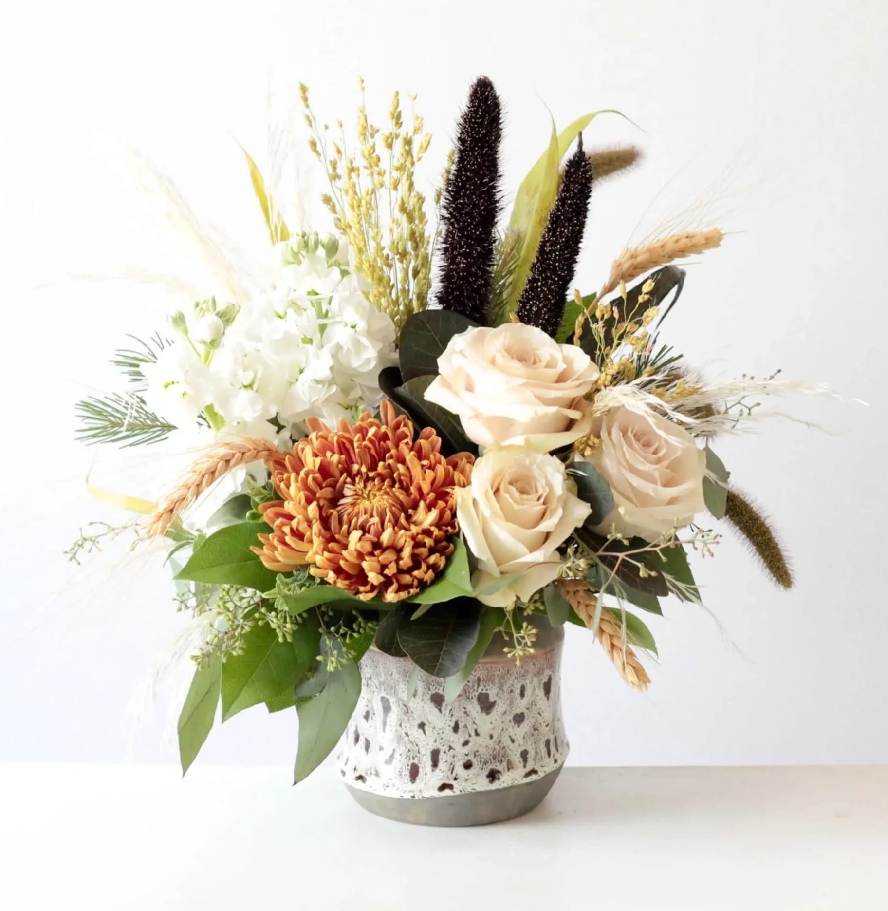 Jade Jade - Premium Ivory roses, soft Dutch hydrangeas, preserved wheat grass and other fall elements makes for this a beautiful gift to give your recipient!