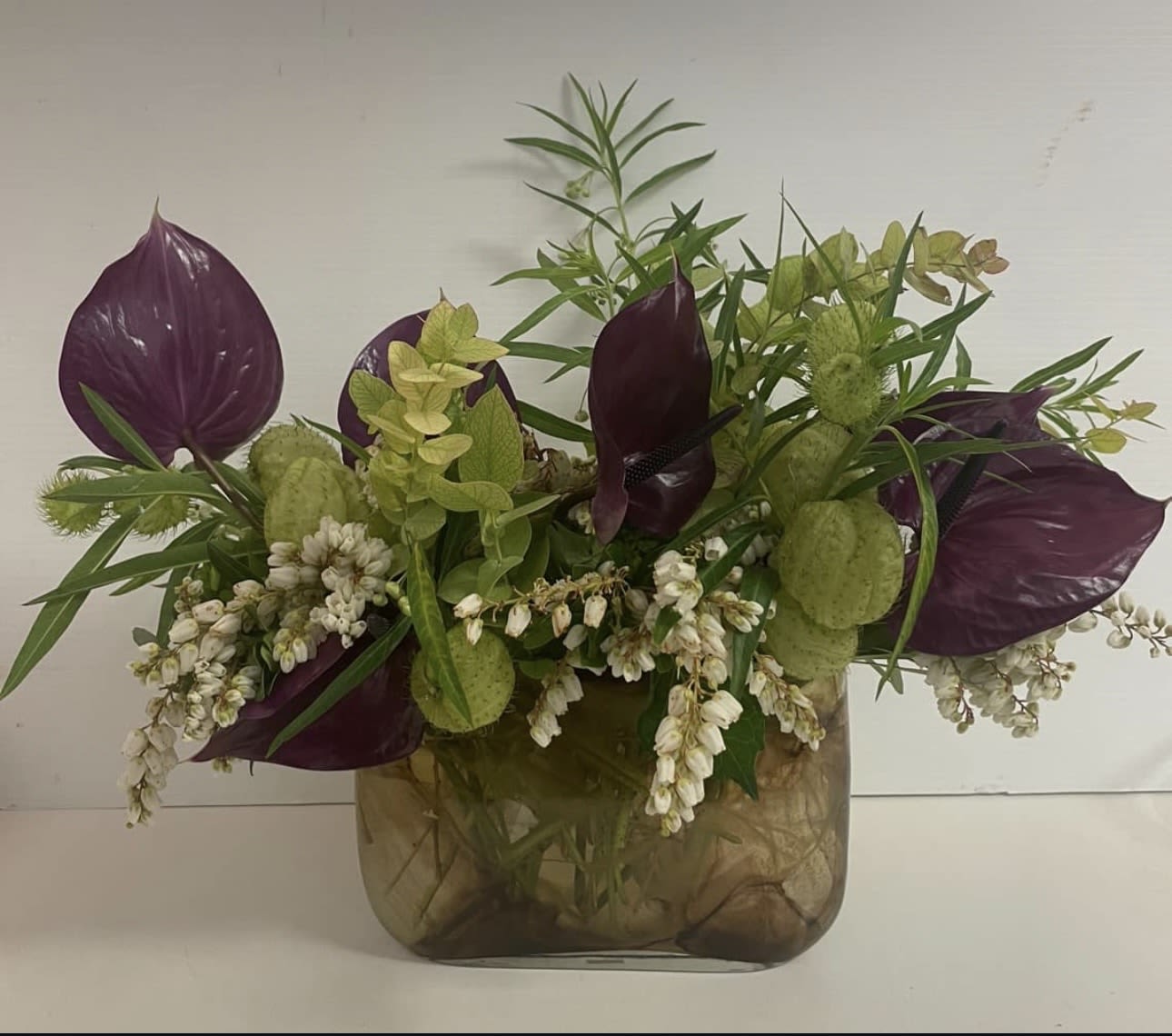 MAMA MIA - Asclepias physocarpa whit a touch of purple anthurium  in a professional vase 