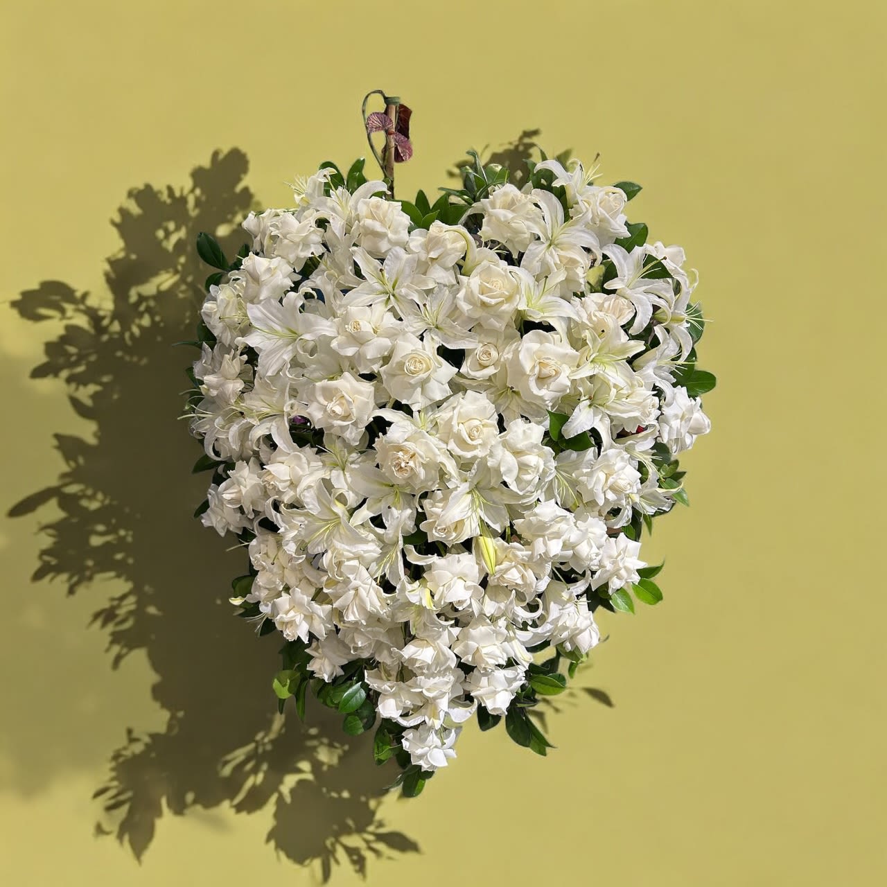 Sweetheart funeral  - An all white tribute, this funeral spray is pure and tranquil. Featuring a variety of white flowers and green palms this elegant funeral spray brings a feeling of peace to it's surroundings