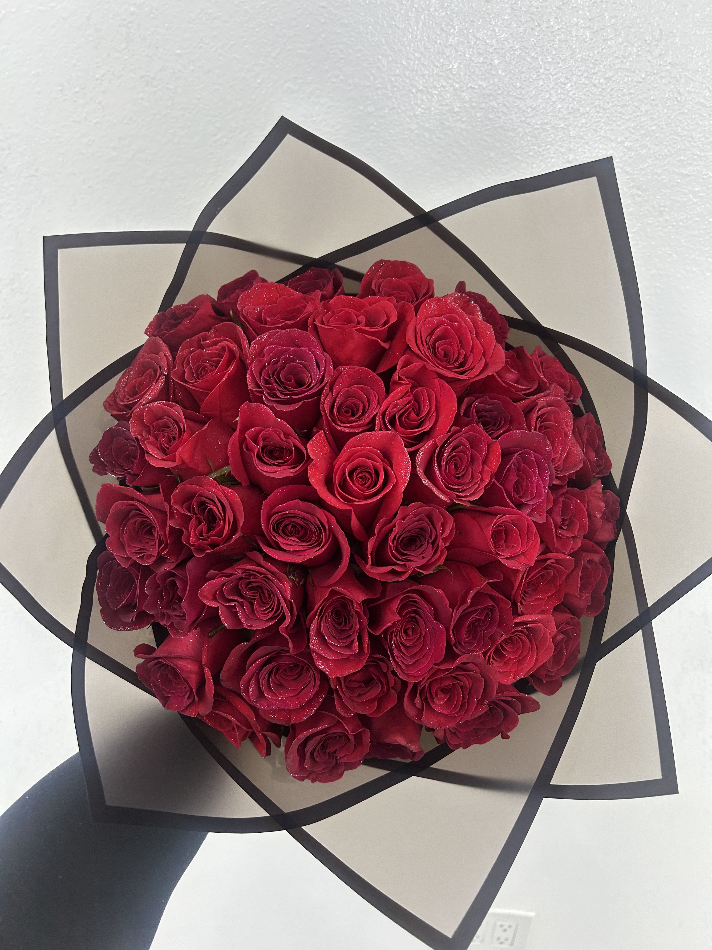 Red Ramo Buchon With Glitter - Beautiful Ramo Buchon in red of 50 roses with silver glitter! If you'd like a specific color of paper please add to the notes what color you'd like! (Does not come in a vase, this is a wrapped bouquet. The stems will also be wrapped in paper with  bow on the bottom. If paper is not available, we will pick one similar.) 