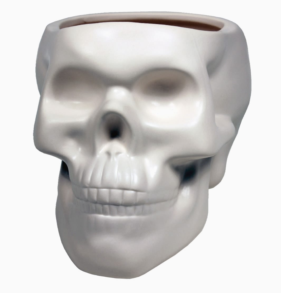 BONE SKULL VASE BONE SKULL VASE - Lush mound of seasonal floral and greenery in our BONE SKULL VASE. Vase Dimensions: 5.3 x 7 x 5.3