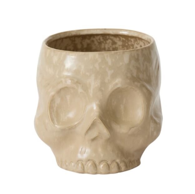 HAUNTING SKULL HAUNTING SKULL - Lush mound of seasonal floral and greenery in our HAUNTING SKULL POT. Vase Dimensions: 6.5 x 7.5 x 6.25