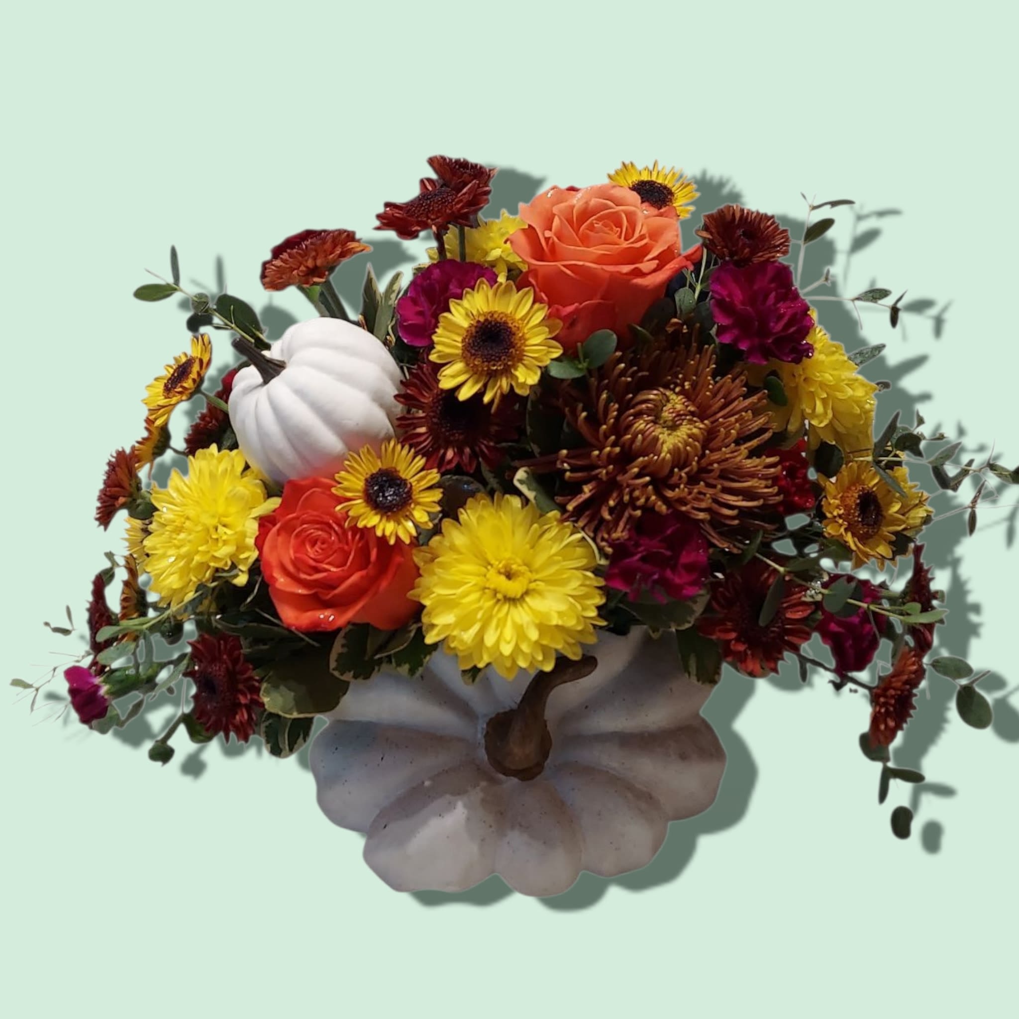 Thankful Ceramic Pumpkin Thankful Ceramic Pumpkin - We always have something to be thankful for! Colorful fall mums, carnations, and roses are adorned with a white pumpkin pic. Approximate size: 12"W x 10"H