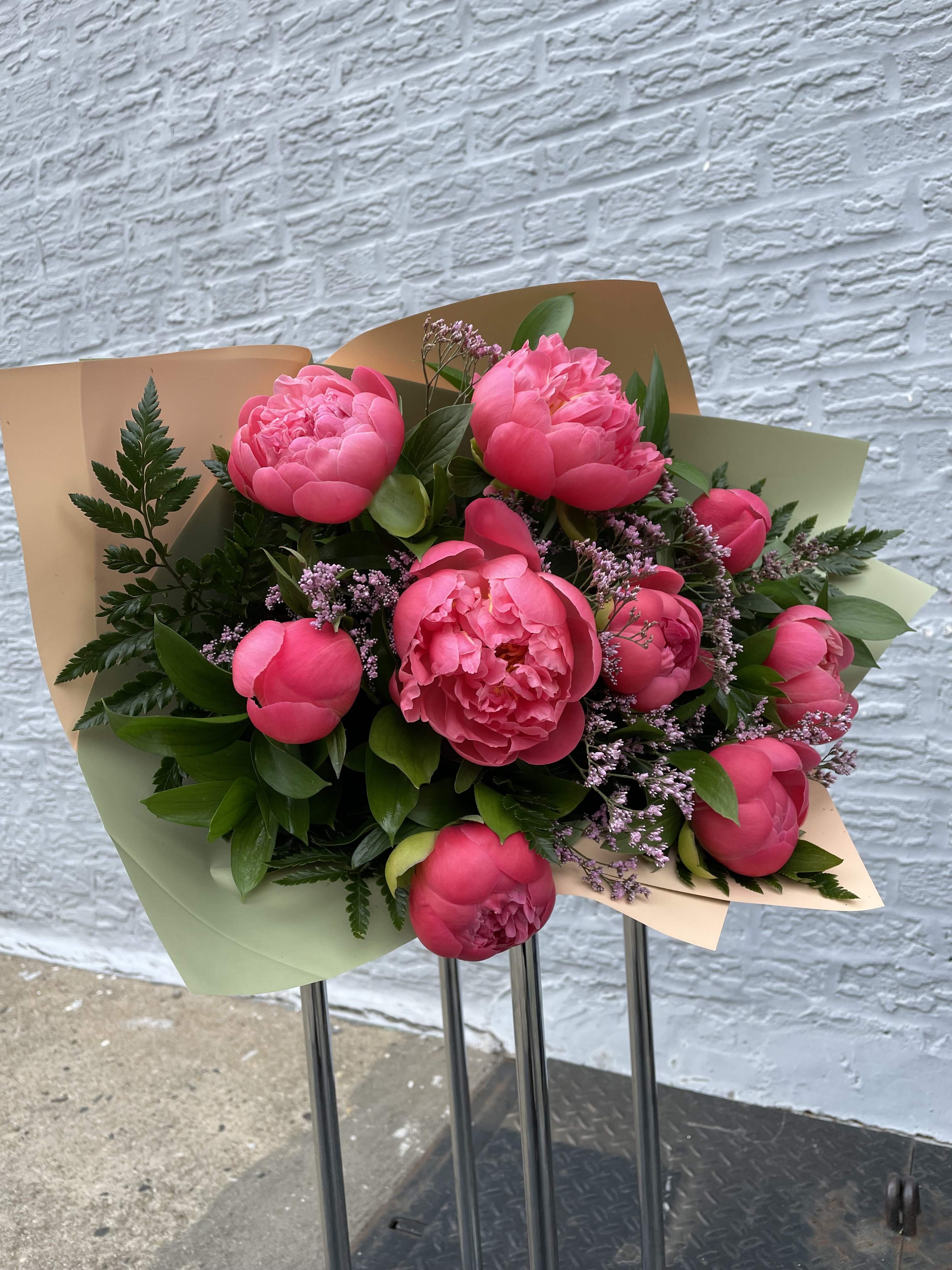 Coral Peonies. The Photo Shows A Deluxe Size. - Fresh Cut beautiful Coral Peonies.   Please call (347) 492 - 5777 for variations and options. Hand Wrapped bouquet.
