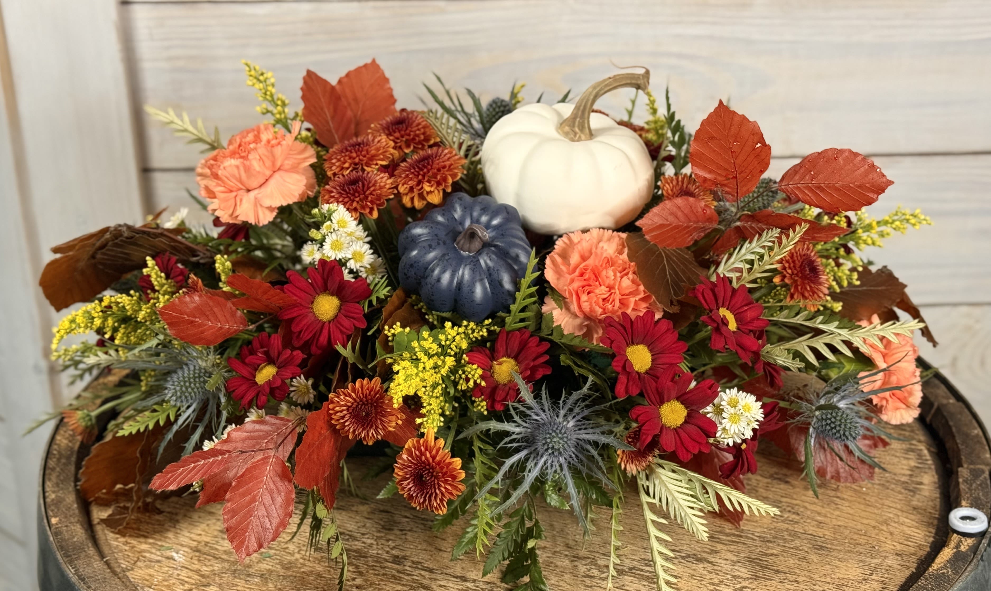 Large Fall Centerpiece - A long centerpiece filled with fresh flowers, leaves and pumpkins.