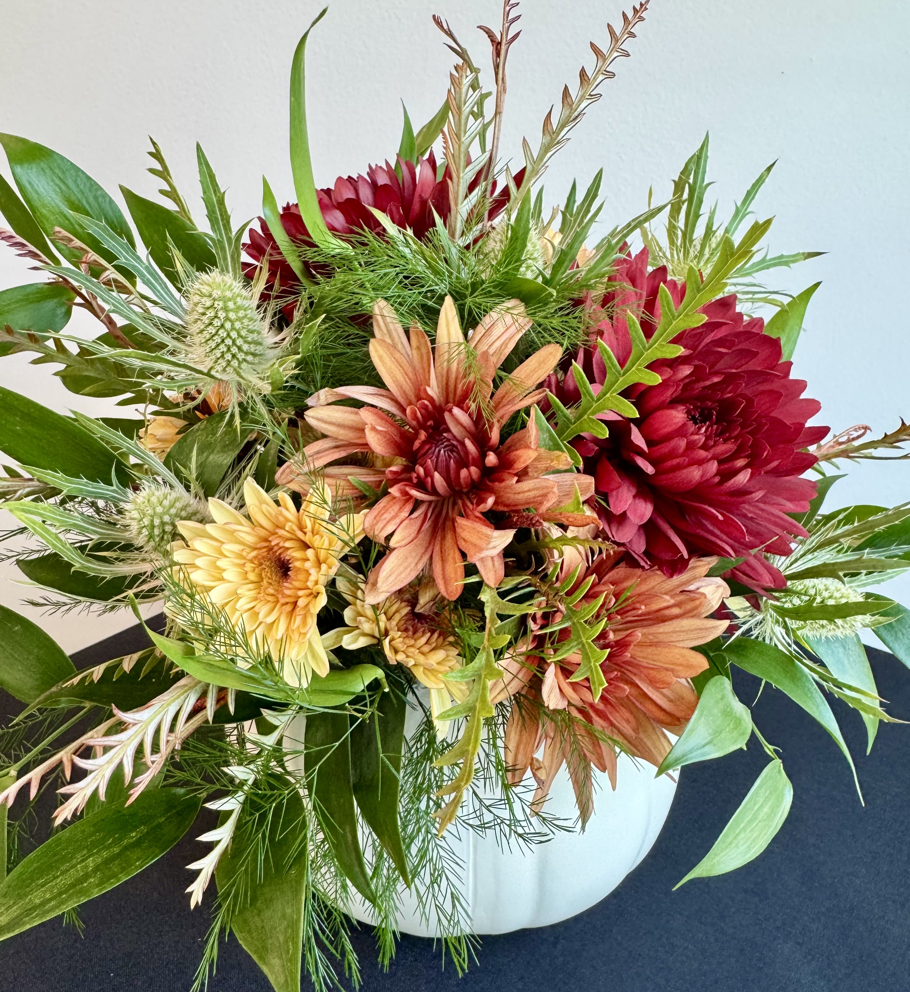 Pretty Pumpkin Arrangement - A beautiful autumn arrangement inside a white faux pumpkin. 