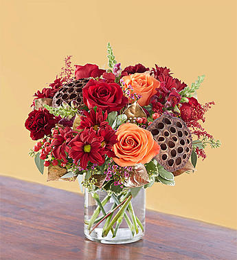 Vintage Autumn Blooms - Just as fall brings a swell of affection and gratitude, our vintage-inspired arrangement overflows with gorgeous autumn blooms. Deep, warm tones combine with rustic textures and design touches, such as gold tinted leaves. Handcrafted by our expert florists, it’s a gift that will bring the beauty of the season into the hearts and homes of those you love.  All-around arrangement of red roses, daisy poms, and hypericum; orange roses; burgundy carnations and snapdragons; accented with red painted solidago, seeded eucalyptus, dried oak leaves, lotus pods, and assorted greenery, including gold-tinted salal  Artistically designed inside a clear glass cylinder Large arrangement measures approximately 15&quot;H x 12&quot;L Medium arrangement measures approximately 14&quot;H x 11&quot;L Small arrangement measures approximately 13&quot;H x 10&quot;L