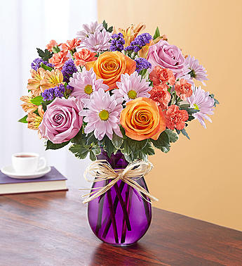 Plum Crazy™ for Fall Plum Crazy™ for Fall - EXCLUSIVE For those who live for leaf-peeping season, here’s an autumn bouquet they’ll be crazy about. Our charming mix of blooms in plums and other autumn hues is handcrafted by our expert florists inside a classic purple vase to highlight the flowers’ beauty. A touch of raffia adds a rustic finishing touch. All-around arrangement of orange roses, mini carnations and Peruvian lilies (alstroemeria); lavender roses and daisy poms; and purple statice; accented with greenery Artistically designed in a purple glass vase; measures 8"H Arrangement measures approximately 14"H x 8"L