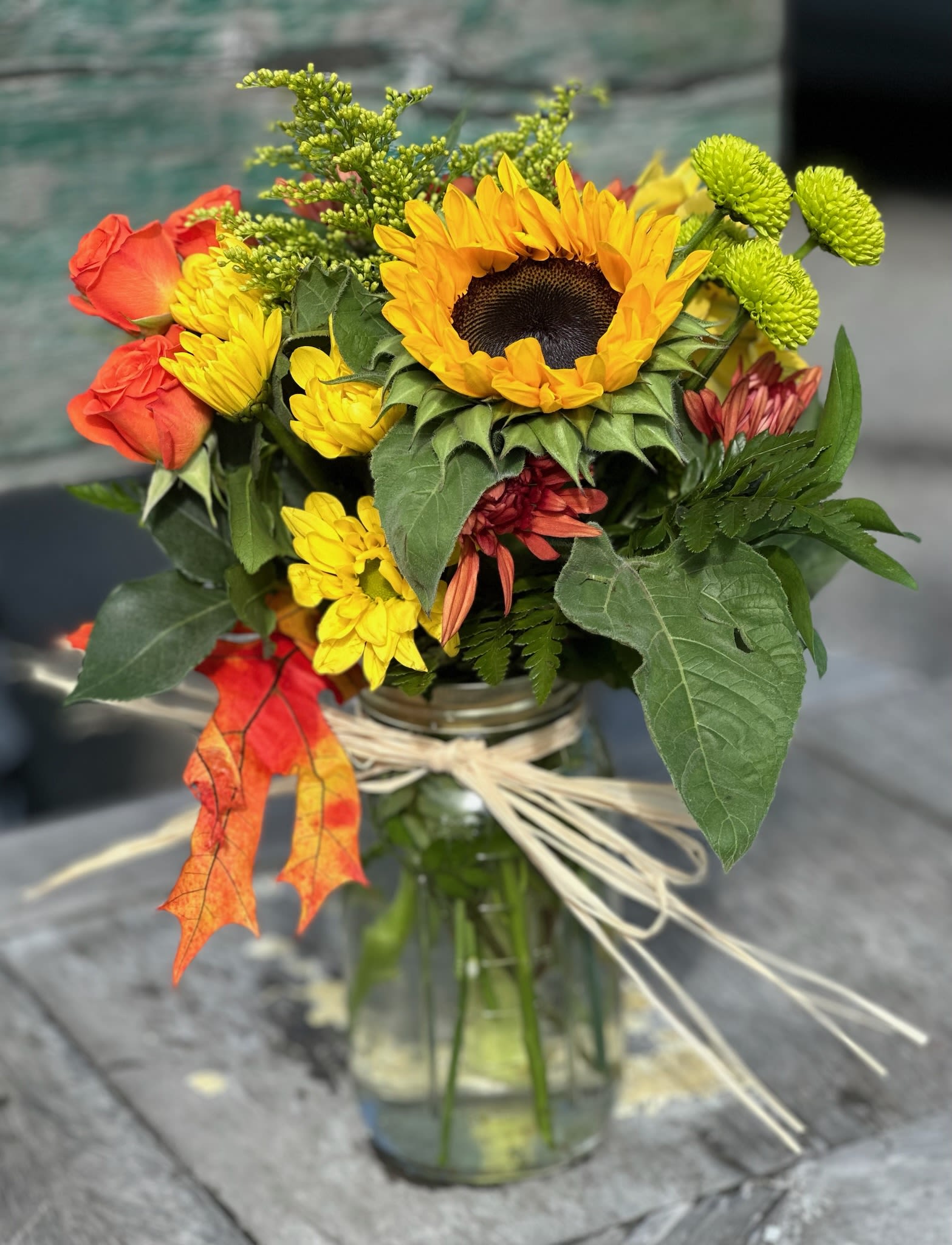 Fall Mason Jar - Sunflowers and other fall colors arranged in a mason jar