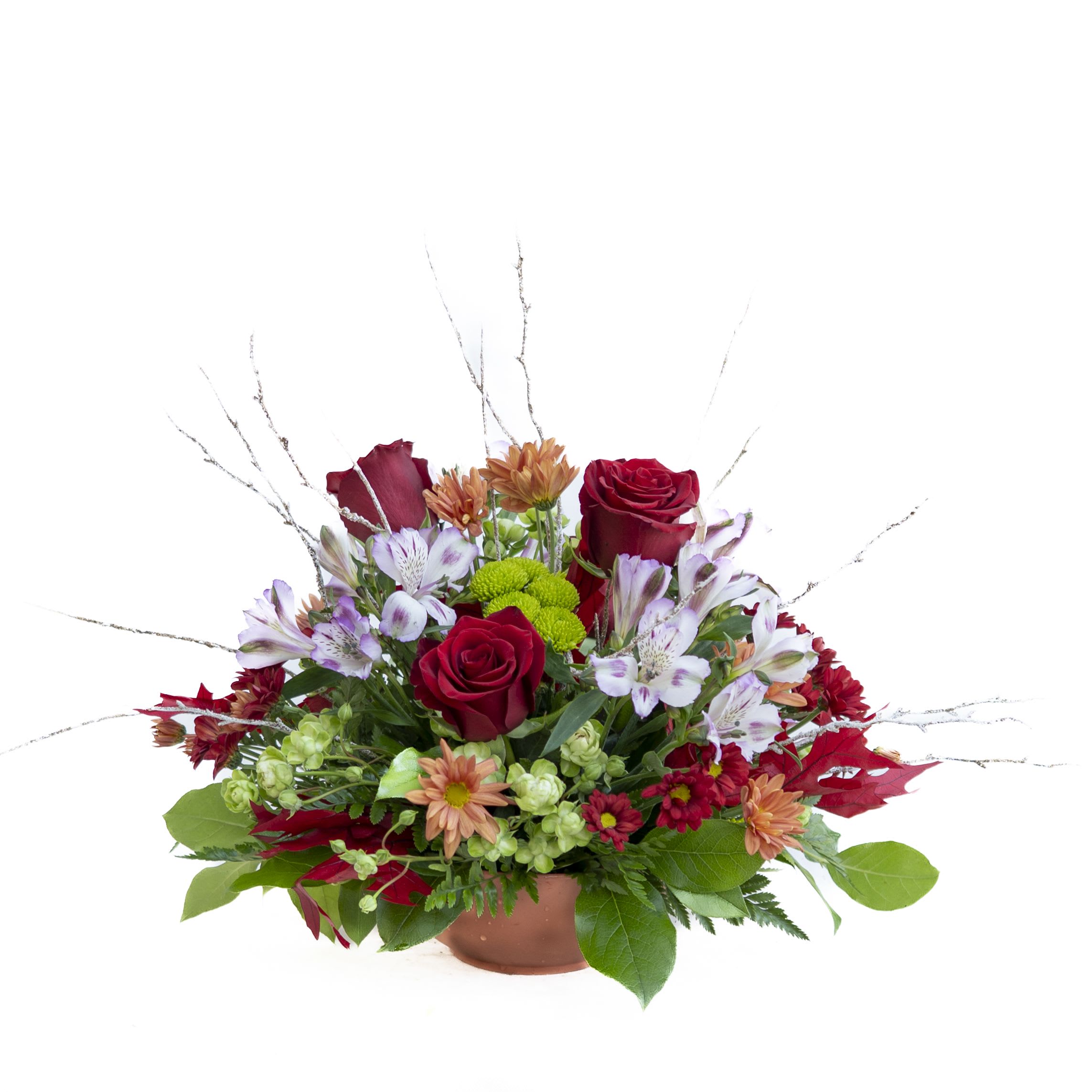 Autumn Radiance Centerpiece Autumn Radiance Centerpiece - Bring warmth and color to your table with our Autumn Radiance Centerpiece. This vibrant design features rich red roses, red daisies, and purple variegated alstroemeria paired with cheerful green spray roses, butterscotch poms, and green button poms. Accented with red autumn leaves and arranged in a rustic terra cotta–style container, this centerpiece perfectly captures the cozy charm of the fall season. Ideal for dining tables, buffets, or festive gatherings.