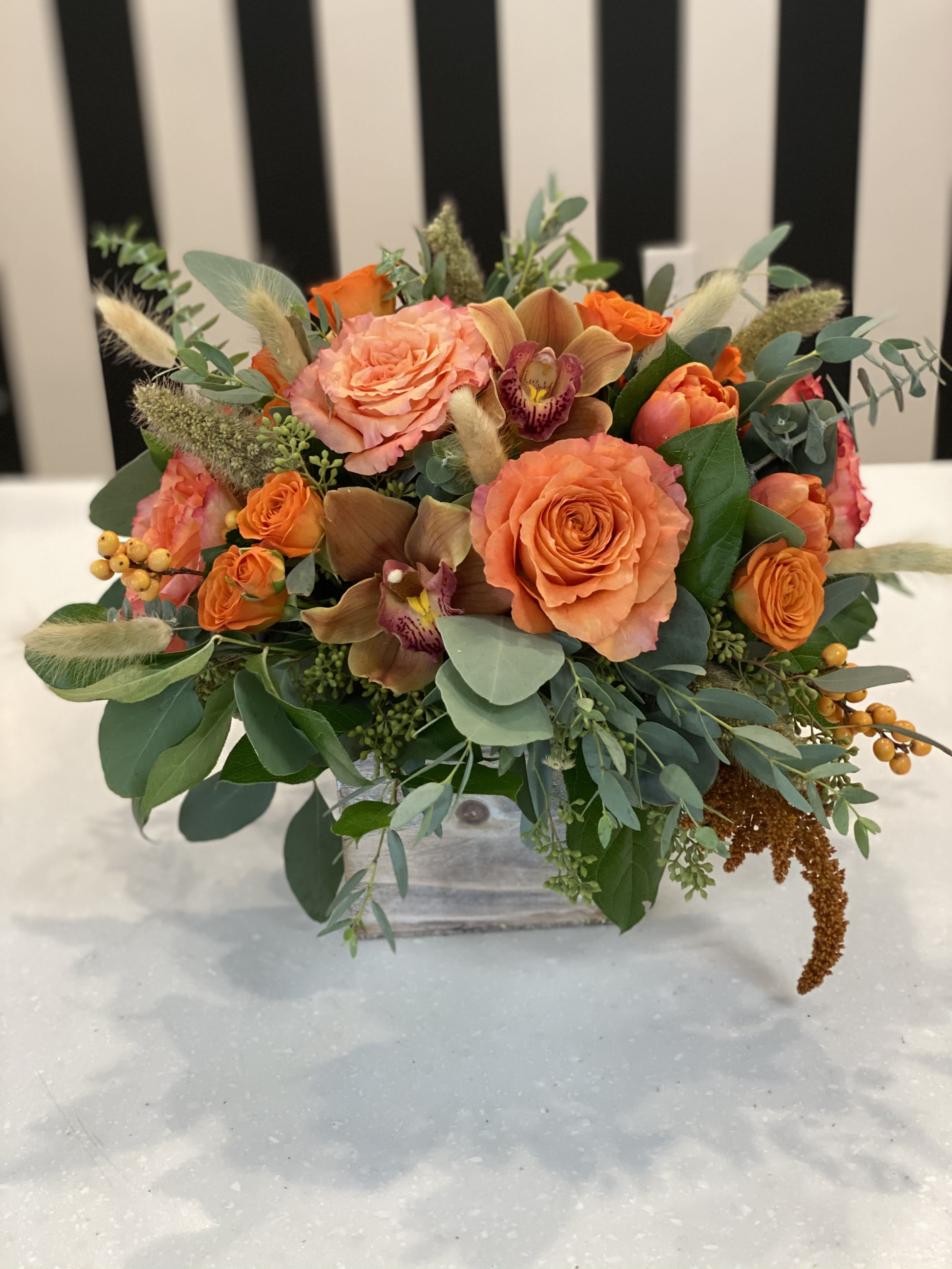 Orange Delight Orange Delight - Wooden box with fall flowers.
