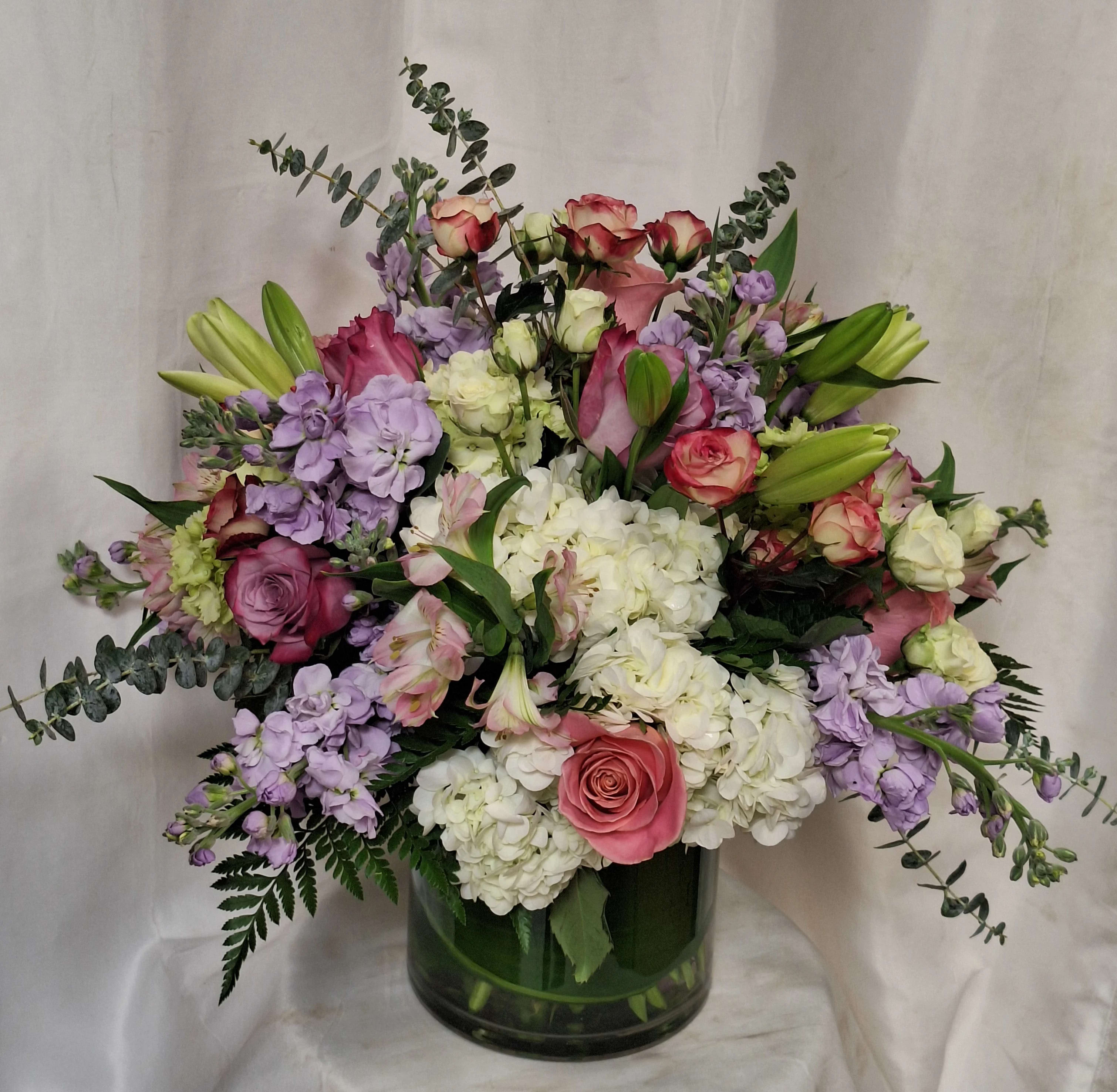 Beauty of Boca Raton (DL) - Introducing our premium floral arrangement, dazzling with shades of green, white, pink and lavender. This stunning ensemble features green and white hydrangeas, white calla lilies, lavender stock, pink roses, eucalyptus, and assorted greenery.