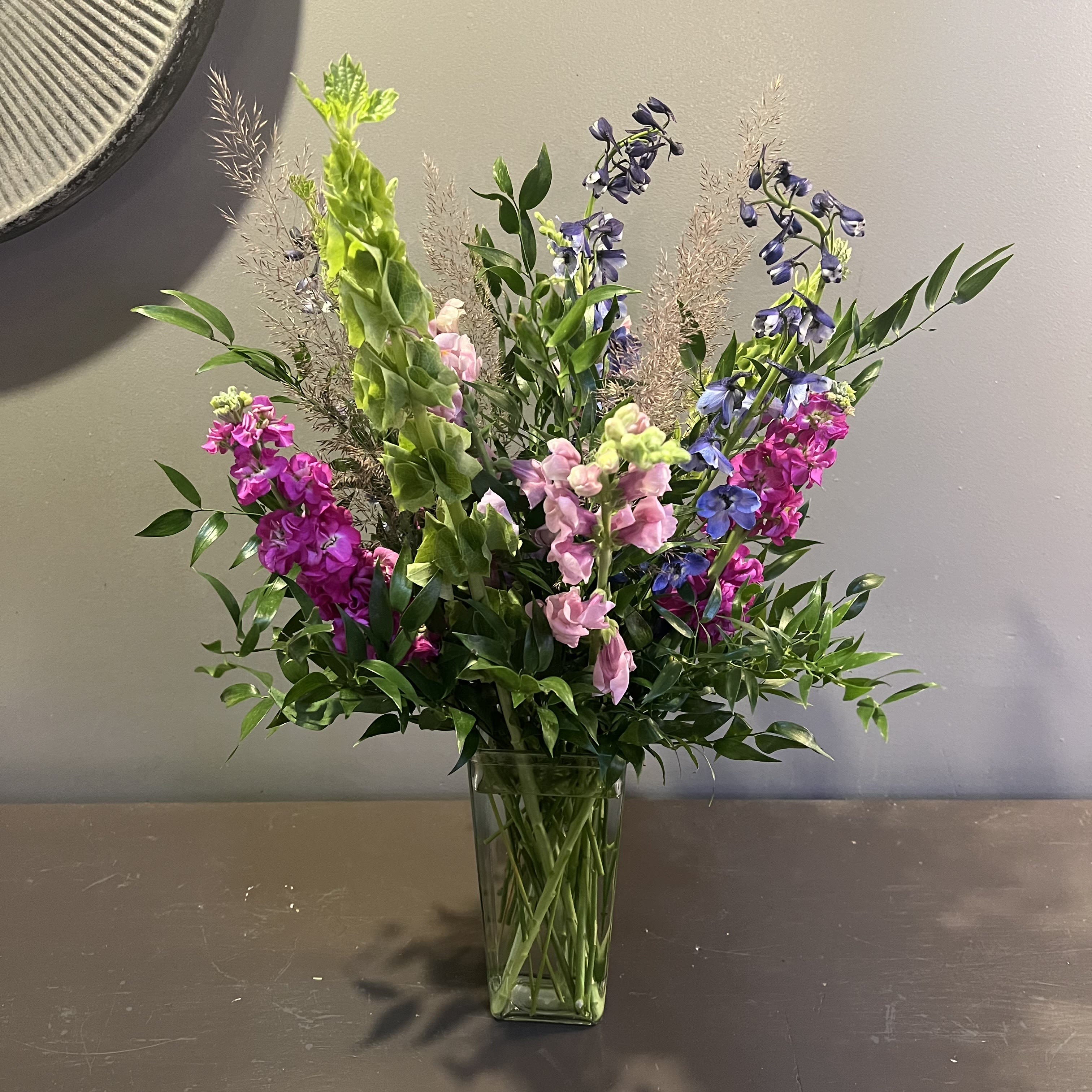 Written in the Stars Written in the Stars - This show-stopping bouquet is filled with snapdragon, delphinium, gladiola, stock, and more. Measures approx. 26Tx17"W