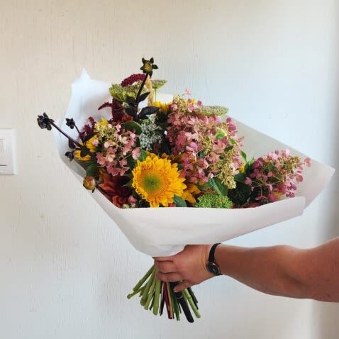 Wrapped Bouquets ( Growers Choice) - A fresh mix of stems chosen for their color and character—ready to be shaped into a personal masterpiece.  Important Note: We are a custom design studio florist in a small town. Every bouquet we create is a one-of-a-kind creation, tailored to the season, availability of flowers, color choice, artistic interpretation, and the current materials available. The photos do not represent the exact flowers that will be delivered. They are intended to provide you with an idea of what we do, how we do it, and the variance that can be expected. 