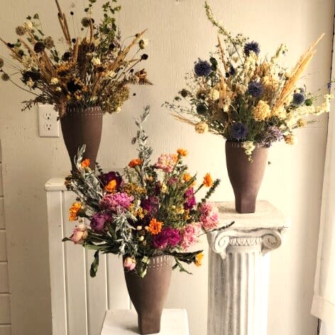 Dried Arrangements (Growers Choice) Dried Arrangements (Growers Choice) - A fresh mix of stems chosen for their color and character—ready to be shaped into a personal masterpiece. Important Note: We are a custom design studio florist in a small town. Every bouquet we create is a one-of-a-kind creation, tailored to the season, availability of flowers, color choice, artistic interpretation, and the current materials available. The photos do not represent the exact flowers that will be delivered. They are intended to provide you with an idea of what we do, how we do it, and the variance that can be expected.