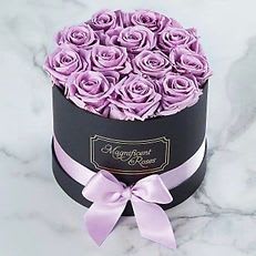 Lavender Luxury Rose Box Lavender Luxury Rose Box - Lavender Luxury Rose Box Elegant and timeless, this stunning hat box is filled with exquisite lavender roses — a symbol of enchantment and love at first sight. Presented in a sleek black box adorned with a satin ribbon, it’s a sophisticated gift that speaks volumes without saying a word. Perfect for anniversaries, birthdays, or to make someone feel truly special.