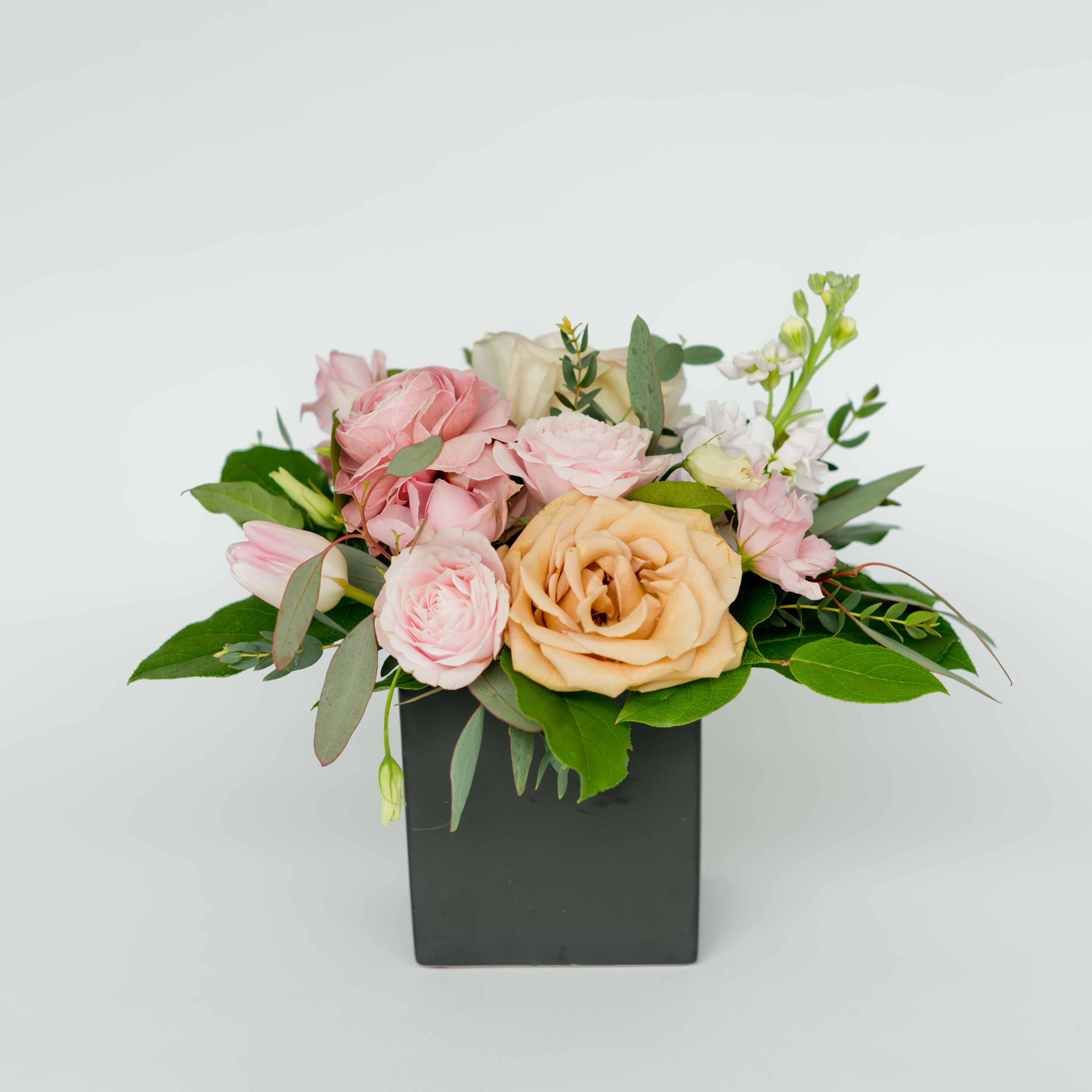 2 | bordeaux 2 | bordeaux - A fan favorite that comes in a ceramic container containing seasonal blooms and foliage. Because of chain shortages, this arrangement will temporarily come in a black or white circle pot.