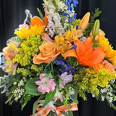 Burst of Sunshine Bouquet Burst of Sunshine Bouquet - Burst of Sunshine Bouquet Radiant and full of life, this vibrant bouquet features golden sunflowers, orange lilies, peach roses, and cheerful accent blooms in shades of pink, yellow, and blue. Finished with a gingham ribbon, it’s a delightful expression of happiness and warmth — perfect for birthdays, celebrations, or simply to brighten someone’s day.