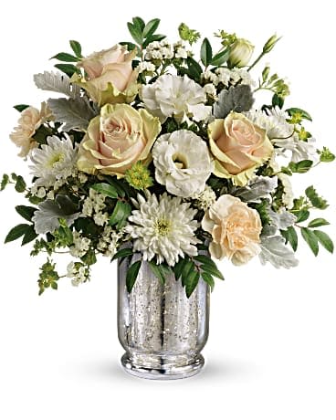 Teleflora's Endless Lovelies Bouquet - Arranged in a vintage-inspired mercury glass hurricane, this gorgeous array of soft peach roses and delicate white lisianthus has a timeless appeal anyone will adore. Later, add a votive to the hurricane for a sparkling glow. This lovely arrangement includes peach roses, peach carnations, white lisianthus, white cushion spray chrysanthemums, white sinuata statice, bupleurum, dusty miller, and huckleberry. Delivered in a Silver Mercury Glass Hurricane.