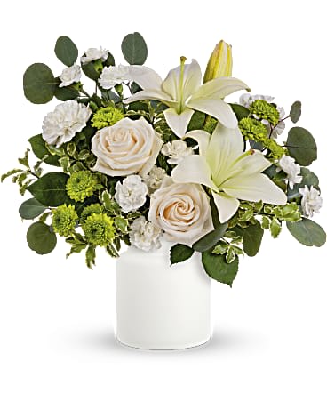 Teleflora's Eternally Elegant Bouquet - This ethereal arrangement is a calming, peaceful gesture that shows them you care. Elegant white blooms accompany a timeless matte white vase. Roses, white lilies and carnations are accented with leaves of fragrant and calming eucalyptus in a timeless matte white vase.