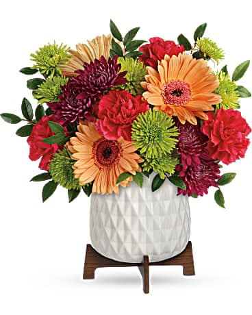 Teleflora's Mid Mod Brights Bouquet - Two gorgeous gifts in one! Celebrate any occasion with this bouquet of bright blooms, stylishly presented in a mod mid-century ceramic planter keepsake! This bright bouquet features hot pink roses, peach gerberas, hot pink carnations, green cushion spray chrysanthemums, purple cushion spray chrysanthemums, and huckleberry. Delivered in a Mid Mod Geometric Planter.