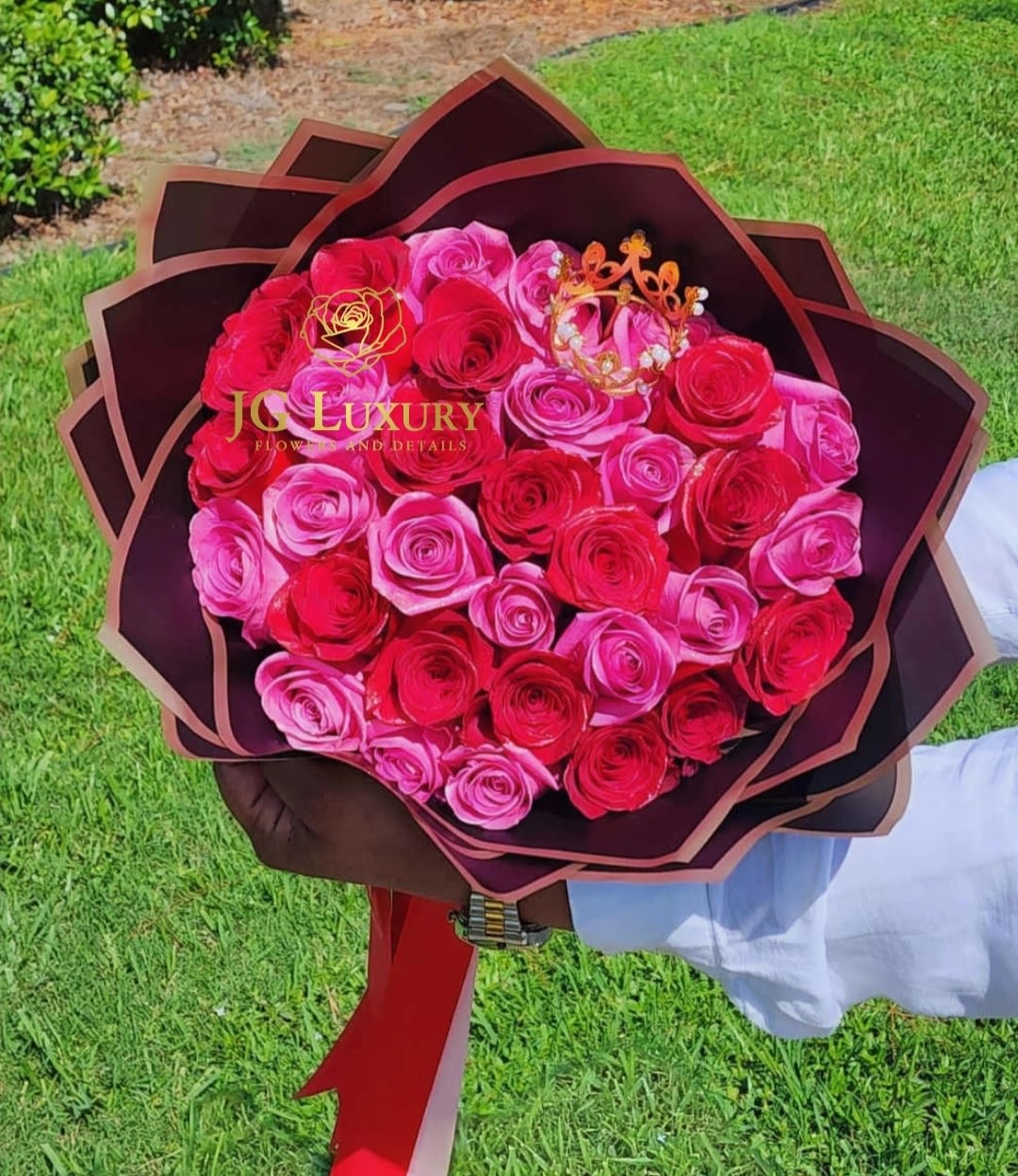 Magenta - Two dozen of red and pink roses with a touch of royalty on the top.