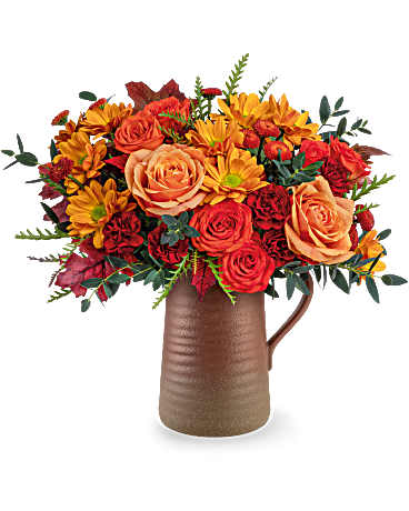 Teleflora's Terra Bloom Bouquet - Brighten the season with the Terra Bloom Bouquet, filled with fall flowers in warm orange and maroon tones. Hand-delivered in a rustic stoneware pitcher, it's a perfect Thanksgiving centerpiece or autumn gift. Terra Bloom Bouquet features orange roses, orange spray roses, maroon miniature carnations, brown button spray chrysanthemums, and orange daisy spray chrysanthemums. Designed with eucalyptus, grevillea, and preserved oak leaves in the Terra Bloom Pitcher-ideal for fall gifting.