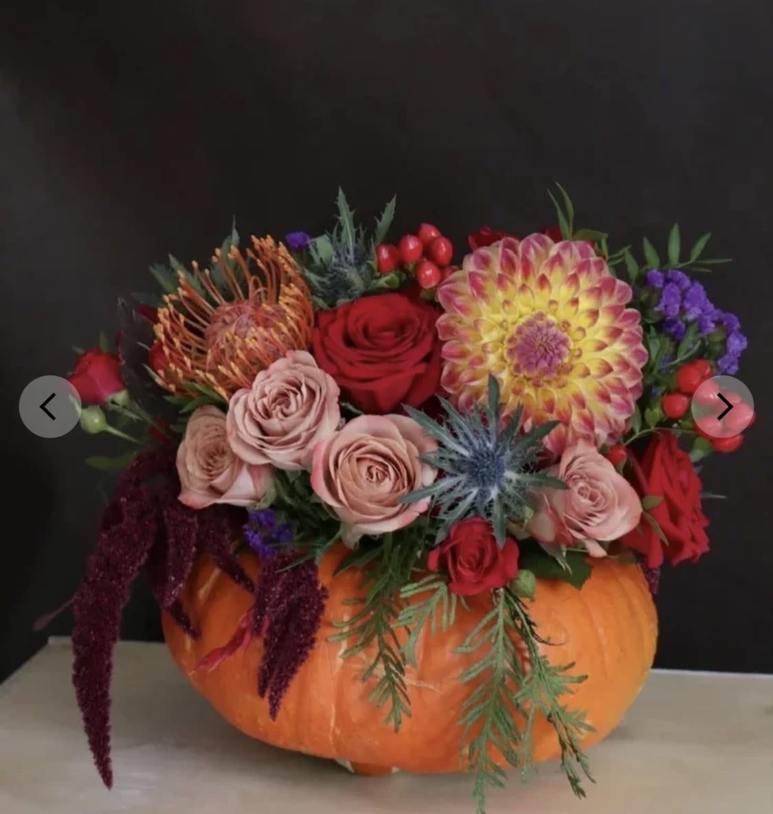 Autumn Glow Autumn Glow - Celebrate the beauty of fall with our "Autumn Glow" bouquet, an exquisite arrangement set in a charming pumpkin vase. This unique design features soft, romantic roses, vibrant dahlias, and whimsical statice, capturing the rich hues of the season. The delicate contrast between the blooms and the natural pumpkin adds a warm, rustic touch, perfect for autumn gatherings or as a stunning centerpiece. Bring the magic of the harvest season into your home or give it as a thoughtful gift—this bouquet embodies the essence of autumn’s warmth and beauty.