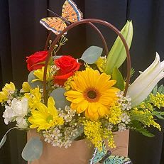 Butterfly Bliss Butterfly Bliss - Bright and cheerful, this delightful floral tote bursts with sunshine! Featuring radiant yellow gerbera daisies, red roses, white lilies, and golden accents of solidago, all arranged in a charming kraft-style bag adorned with fluttering butterflies. Perfect for birthdays, thank-you gifts, or simply to brighten someone’s day.