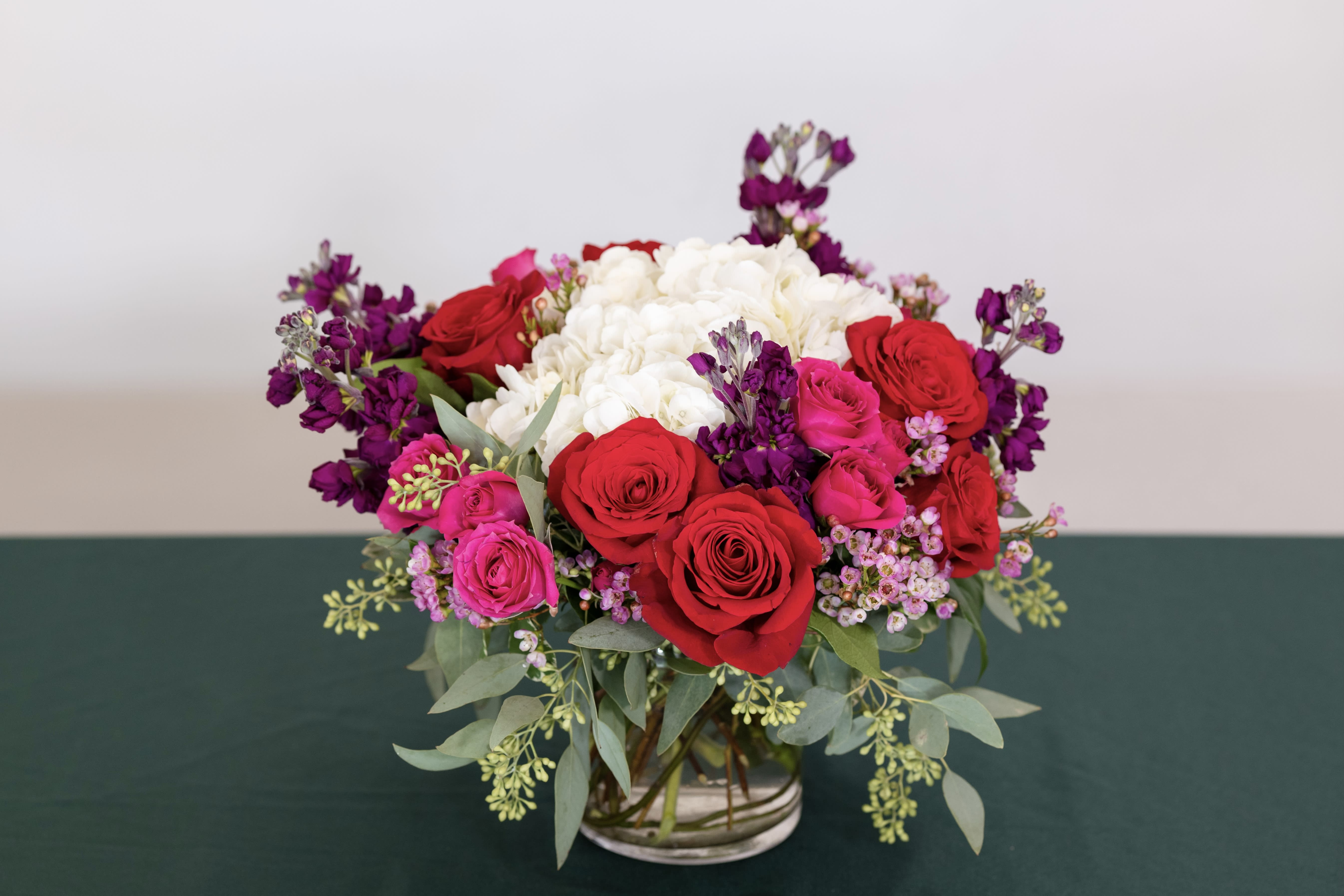 Love Always Love Always - Let her know she's special with our 'Love Always' design featuring romantic Ecuadorian roses and fragrant fuchsia stock nestled in a cloud of white hydrangea, lisianthus and seeded eucalyptus.