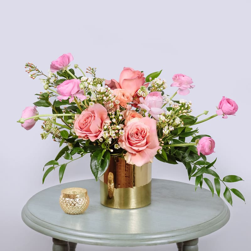 Sweetheart Candy - Be Mine. You're Cute. XOXO. Cutie Pie. For the ultimate sweetheart in your life. This cutie is filled with Pink Roses, Ranunculus, Wax Flower, and Italian Ruscus.