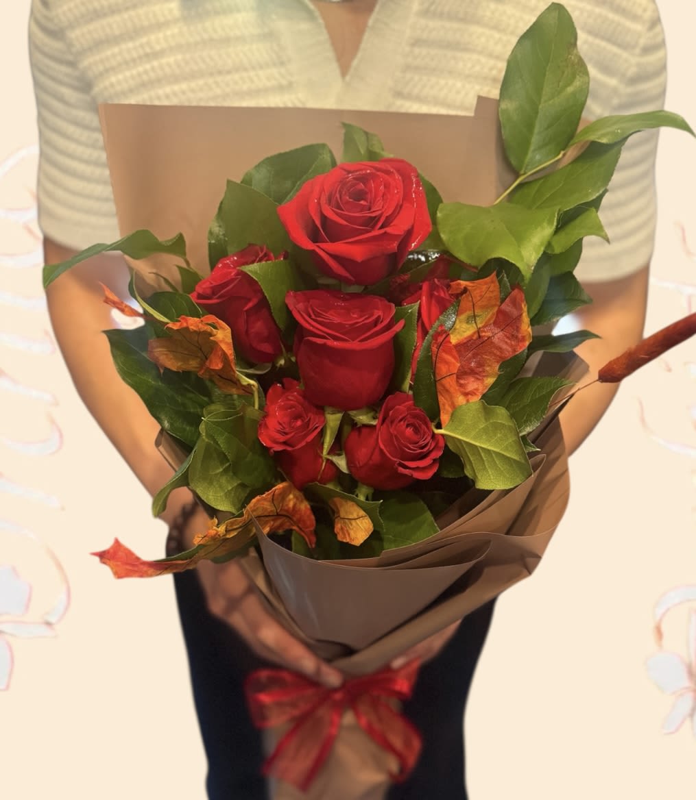 Fall Short Stem Roses Wrapped Bouquet Fall Short Stem Roses Wrapped Bouquet - Beautiful short-stemmed red roses wrapped in brown parchment paper, accented with fall greenery. Available in half-dozen, 13 roses, or 18 roses, perfect for any day or special occasion, or simply brightening someone's day.