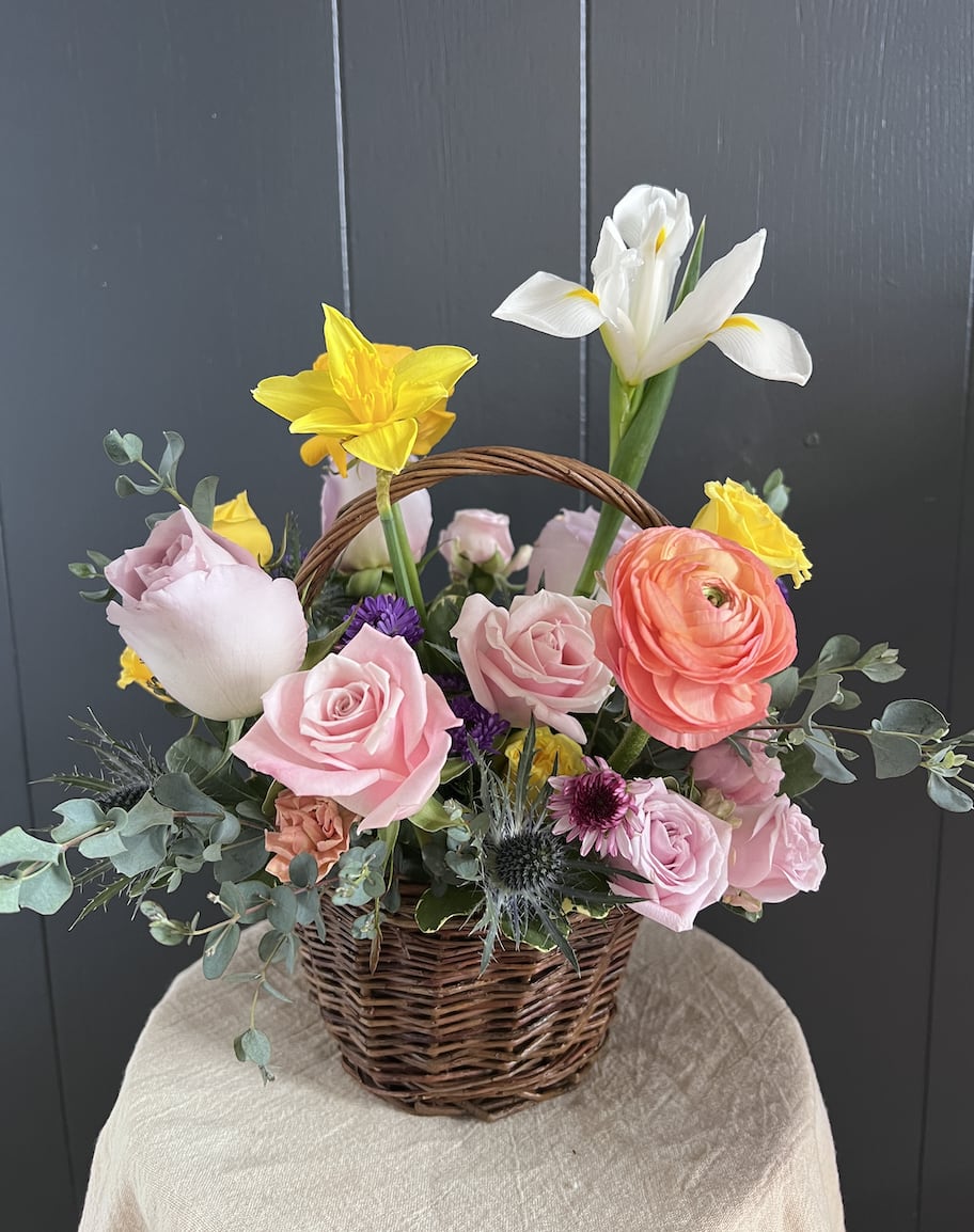 PETITE SEASONAL BASKET - Seasonal, colorful flowers and foliage artfully arranged in circular woven basket.  Year round flowers that we typically stock: specialty rose, spray rose and garden rose, ranunculus, anemone, gerbera daisy, protea, lisianthus, chrysanthemum, larkspur, snapdragon, delphinium, stock, aster, dianthus, hypericum, feverfew, astrantia, leucodendron