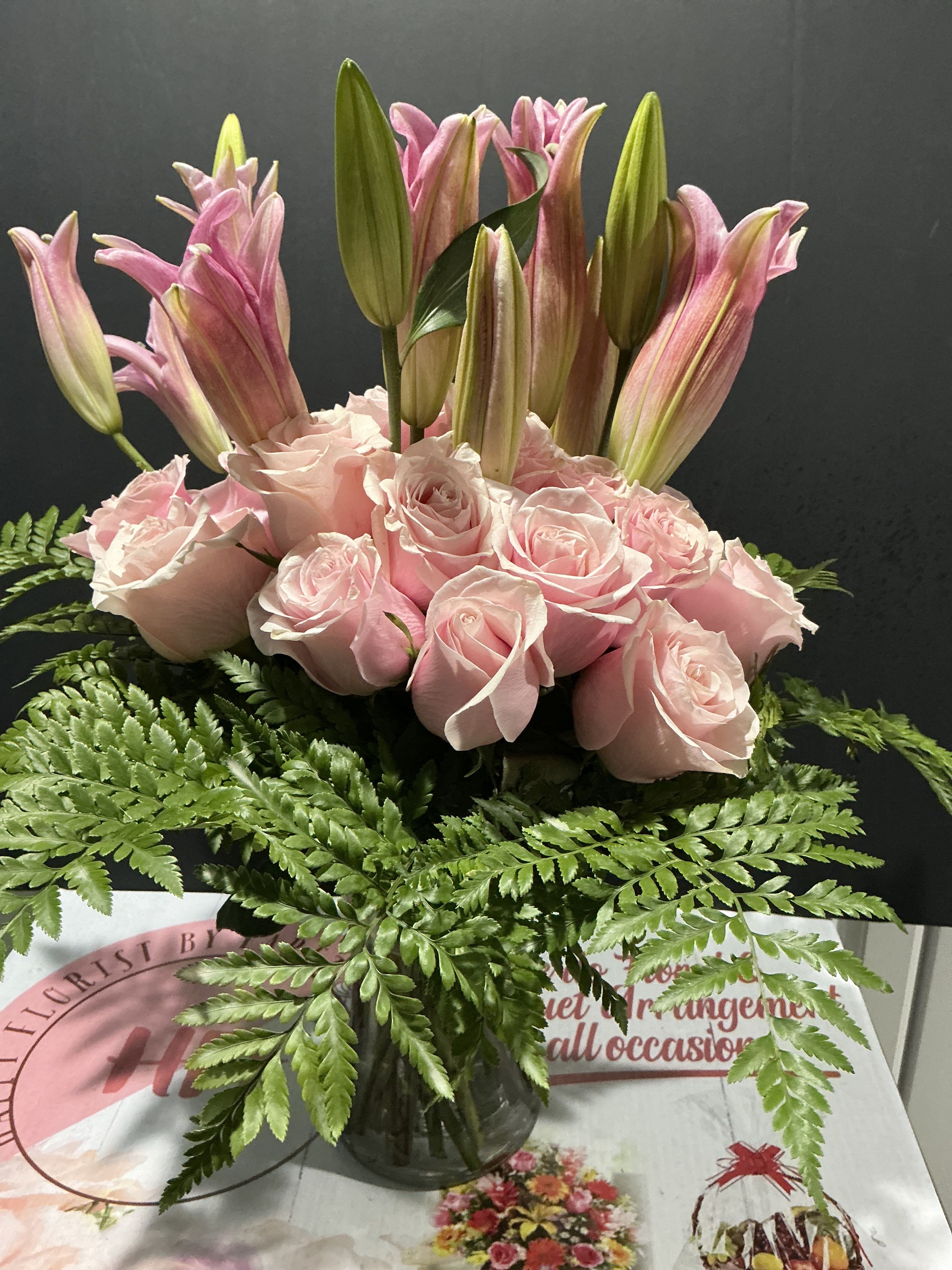 Bright pink bouquet - This floral arrangement was designed to welcome a baby girl to a loving home   18 pink roses 1lily for standard   22roses 2lilies deluxe 24roses 3 lilies for premium  15W 23T