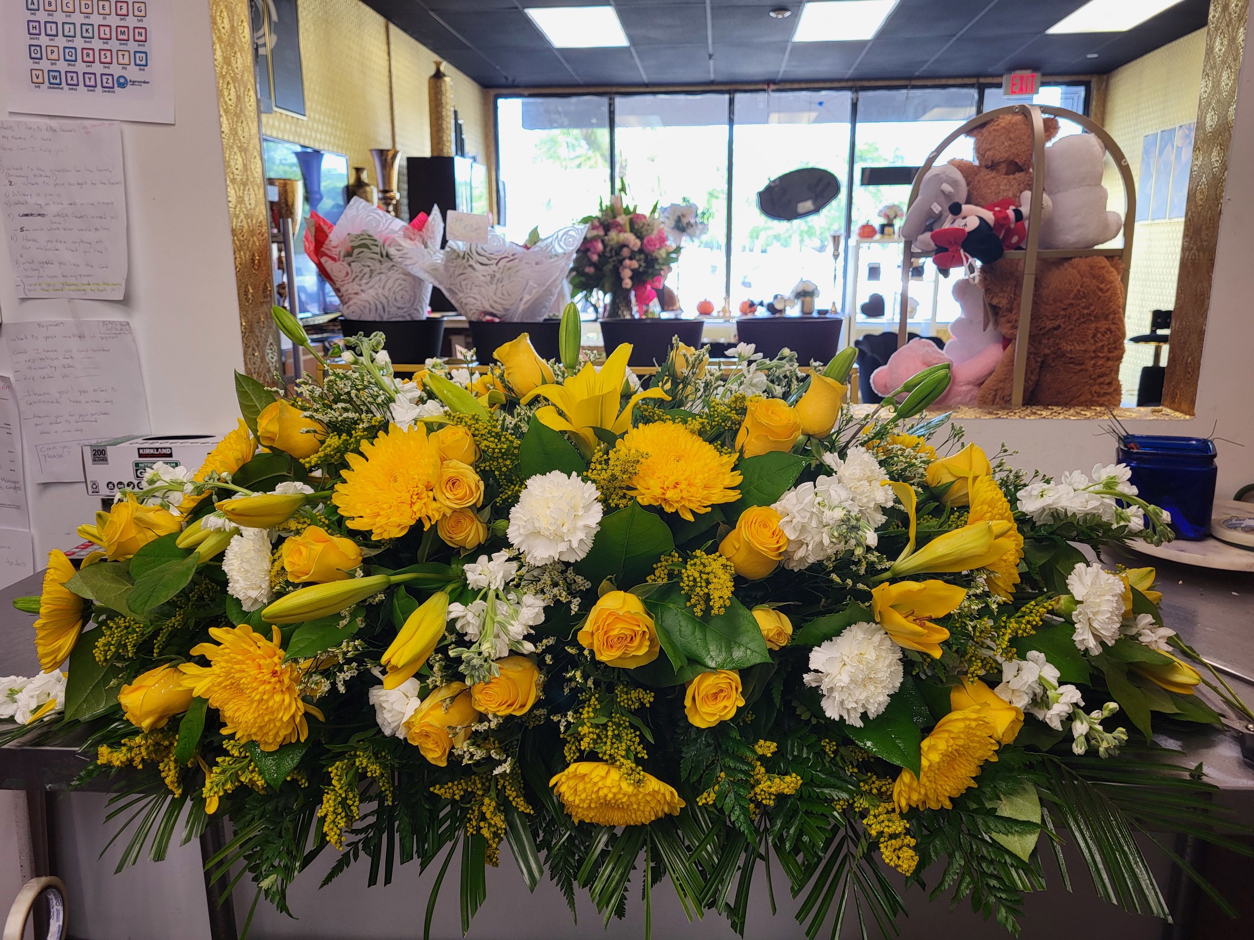 Forever Serenity Forever Serenity - ELLIE FLOWERS exclusive arrangement,featuring premium grade A yellow roses, white carnations, baby breath, solidago,yellow crysanthemums,lilies,limonium and greeneries.
