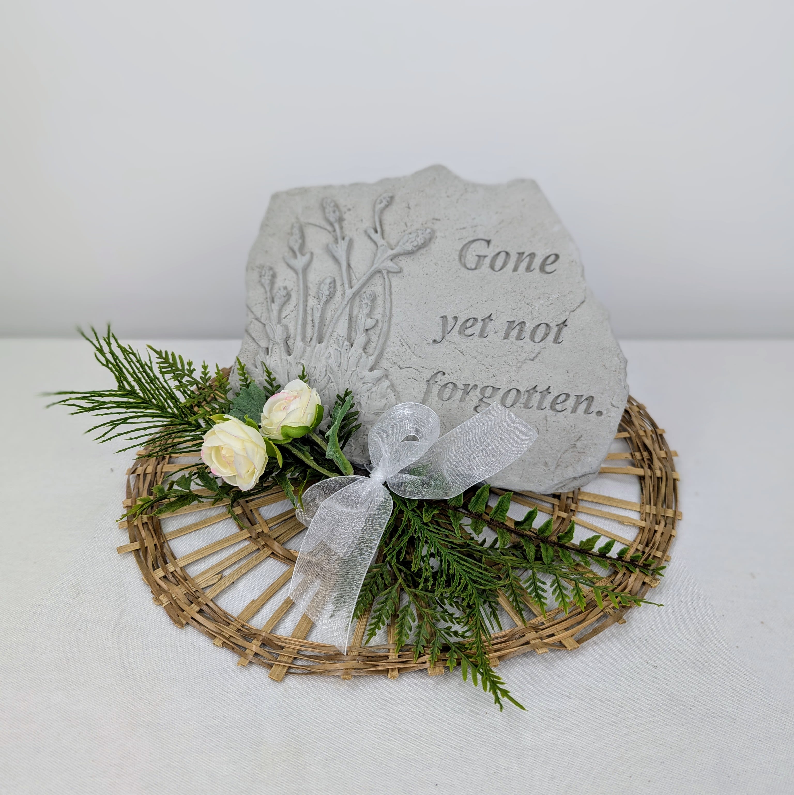 Memorial Stone #1 - Memorial stone sitting on easel, with artificial decor and a ribbon.  &quot;Gone yet not forgotten.&quot;