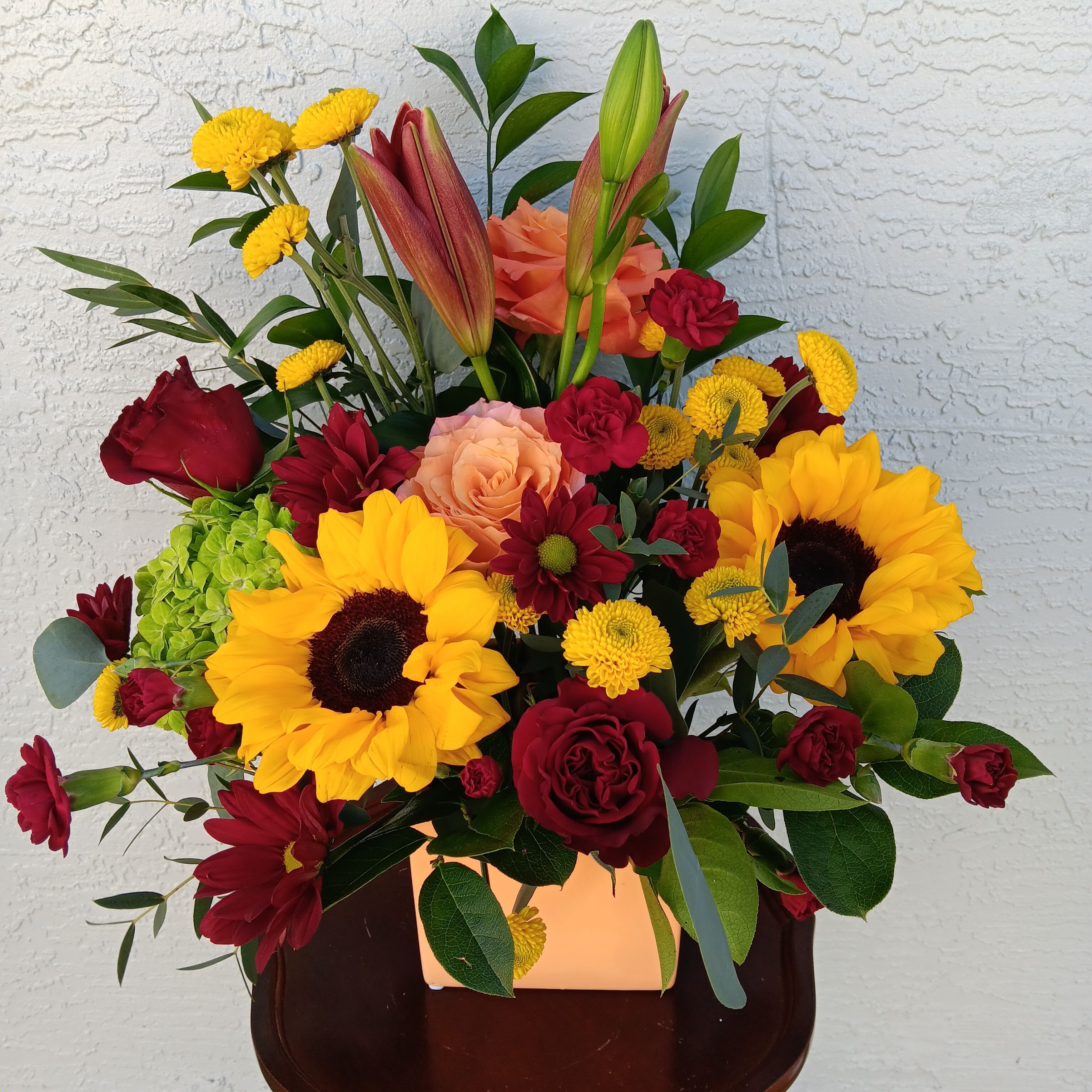 Dazzling Harvest Dazzling Harvest - Roses, sunflowers, and more arranged in 5" orange ceramic cube.