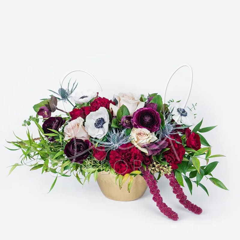 Feeling Moody - Our Feeling Moody arrangement captures bold elegance with deep merlot, black, navy, and soft nude blush tones. Accented with touches of gold, this lush, full-sided floral design creates a stunning statement for any occasion. Presented in a sleek metal brass Jema bowl (4.5”), it’s perfect for adding a touch of drama and sophistication to your home or event.