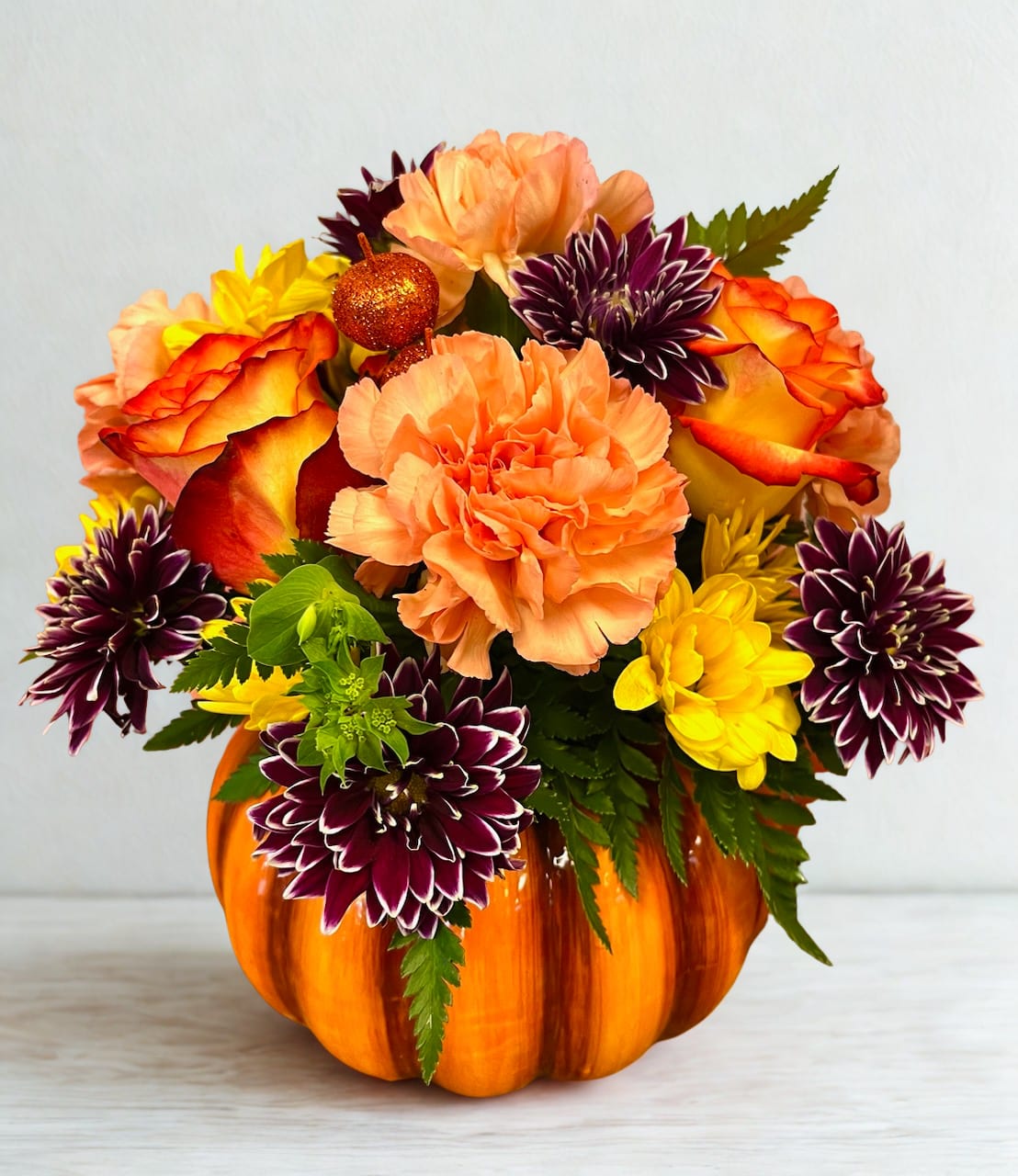 Pumpkin Spice - Ceramic pumpkin container. Beautiful orange roses and mums in the colors of fall will look perfect on your holiday table.