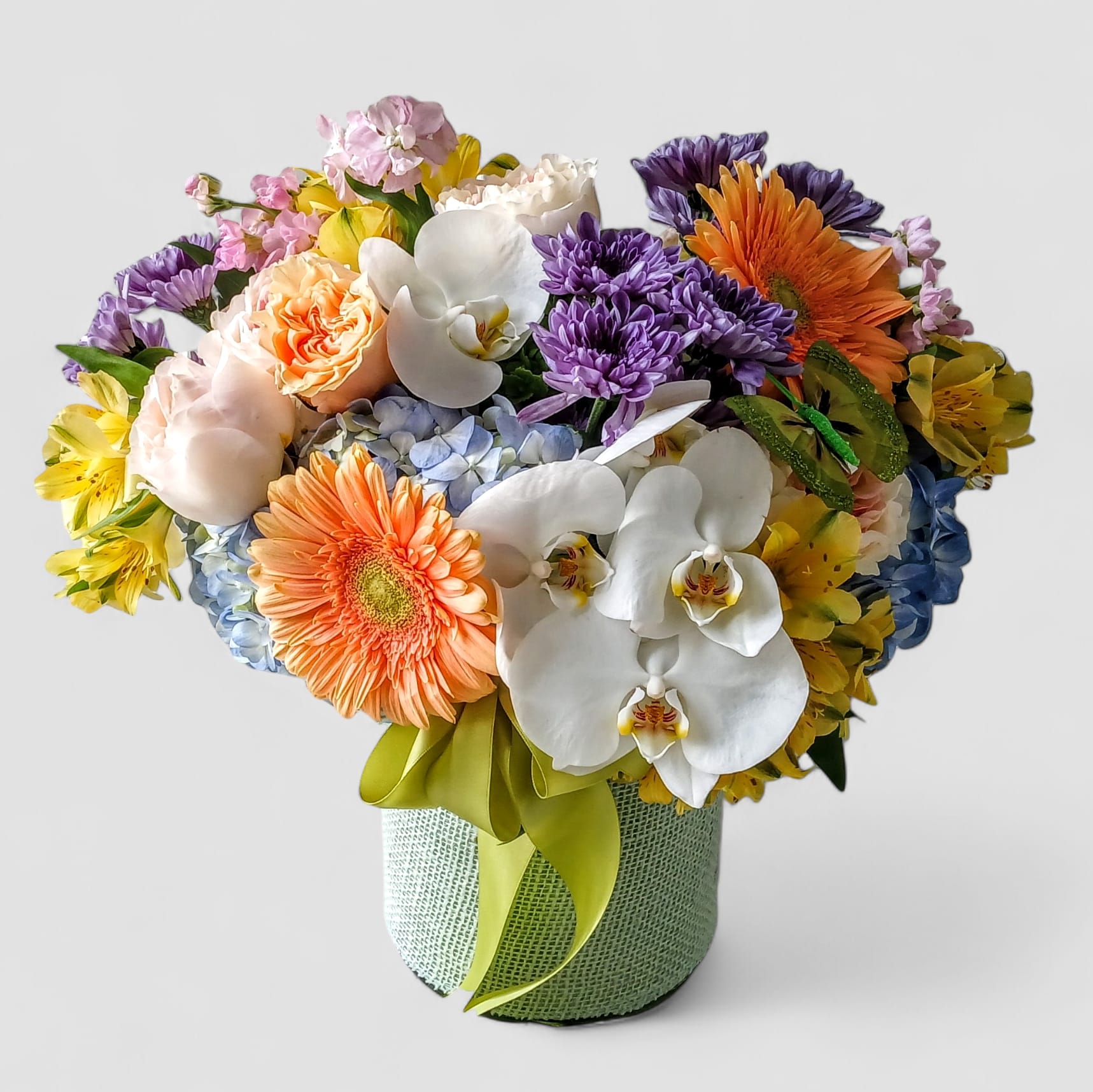 Colorful Orchid &amp; Rose Happiness Bouquet - Same Day Flower Delivery Haddonfield &amp; Cherry Hill - Brighten someone's day with our Colorful Orchid &amp; Rose Happiness Bouquet, a vibrant mix of orchids, roses, hydrangeas, gerbera daisies, and seasonal blooms. Hand-arranged in a tall modern glass vase and tied with a charming blue jute ribbon, this cheerful bouquet is perfect for birthdays, anniversaries, get well wishes, or simply to say &quot;you're loved.&quot;  At Joey-Lynn's Flowers in Haddon Township, we create every arrangement fresh from the heart-no two are ever alike. We proudly offer same day flower delivery to Haddonfield, Cherry Hill, Marlton, Voorhees, Mount Laurel, and surrounding towns, making it easy to send beauty and happiness right when it's needed most.