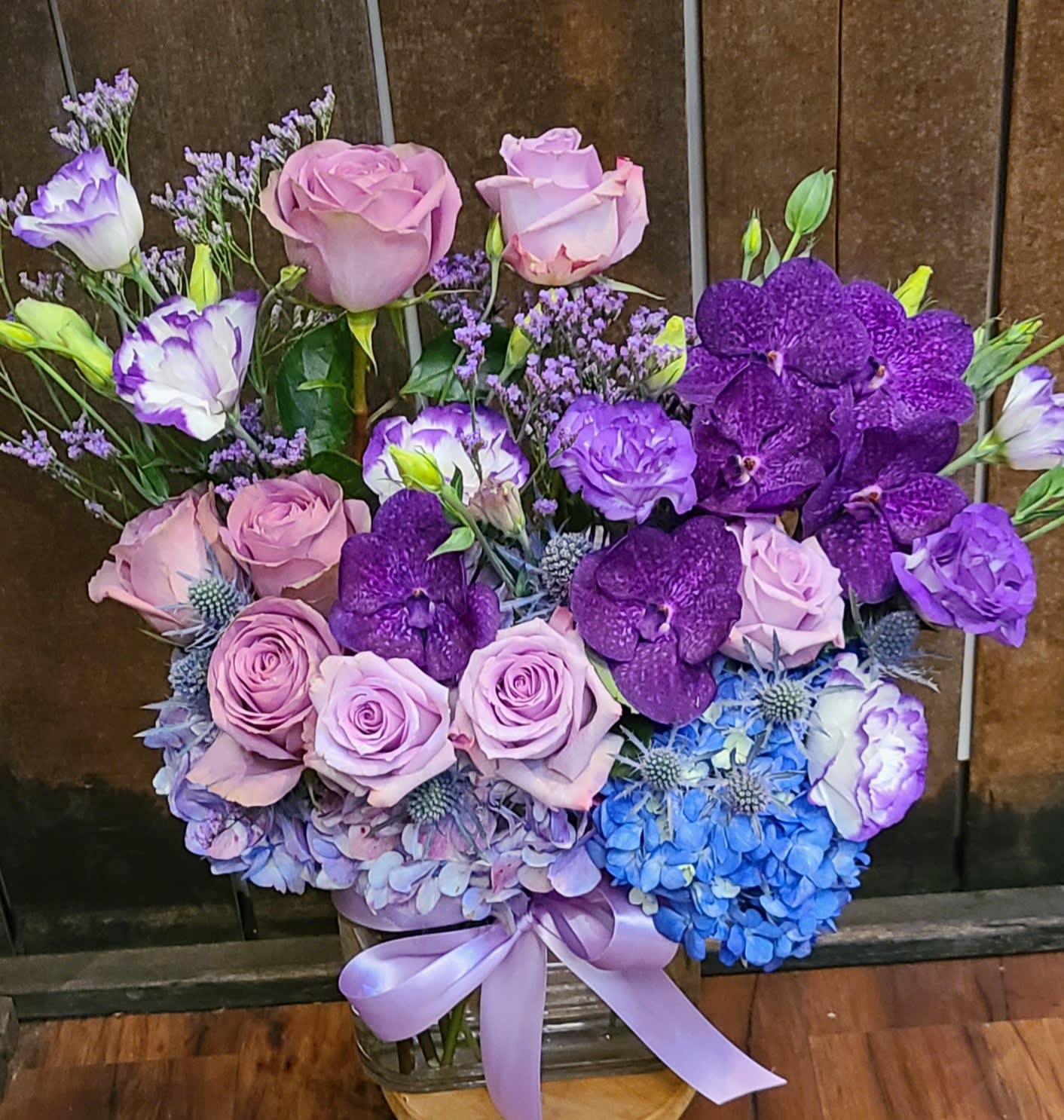 Purple passion - A combination of stunning and vibrant blues and purples arranged in a glass vase.