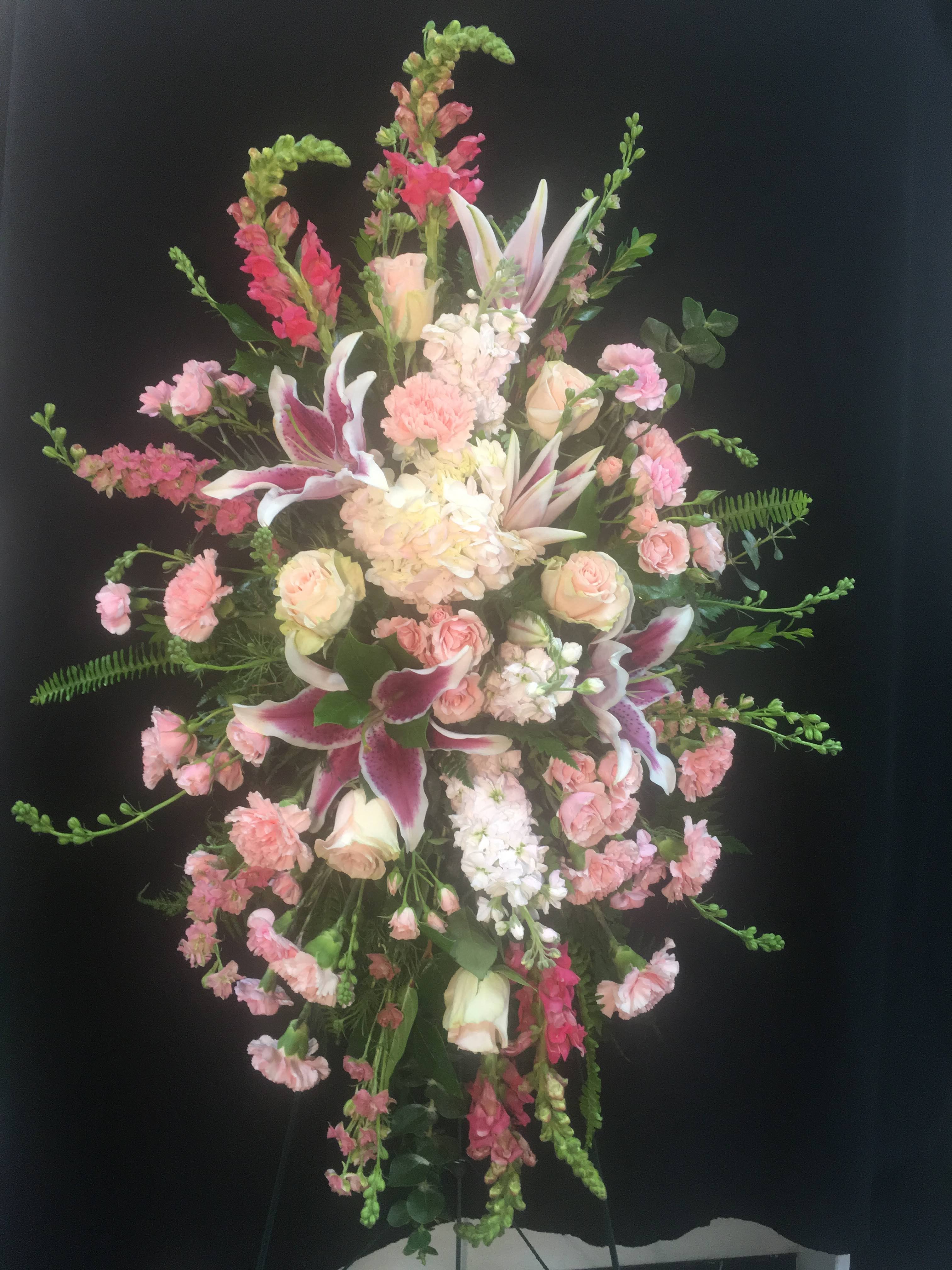 Remembrance of you - Standing spray pink and white  stargazer lilies, snap dragons, roses, spray roses, hydrangeas, stock, larxpur , carnations, mini carnations and mixed greens 