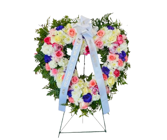 Breeze of Love - This stunning funeral standing heart wreath features pink, purple and lavender roses,  white carnations, white mums, and hydrangeas.The heart-shaped design symbolizes love and remembrance, offering a heartfelt tribute to the departed. All our flowers are imported directly form the farms.  Includes:  Roses Spiders Hydrangeas Greenery Standing Spray and Wreath 
