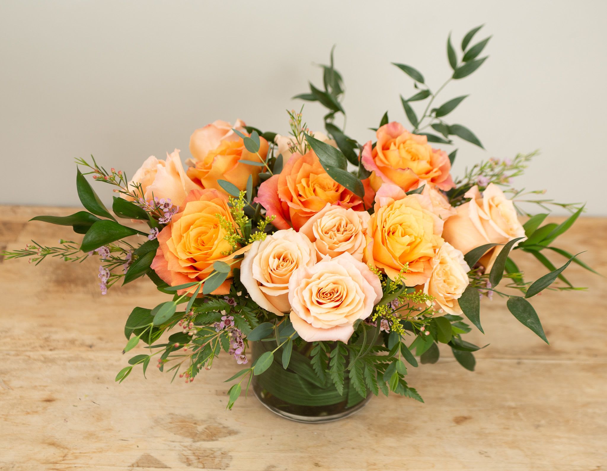 Apricot Glow Apricot Glow - Radiating warmth and effortless beauty, Summer Glow features a luminous blend of orange and apricot-hued roses, accented with seasonal textures and soft greenery. This vibrant arrangement captures the golden light of long summer days—cheerful, uplifting, and full of heartfelt charm.