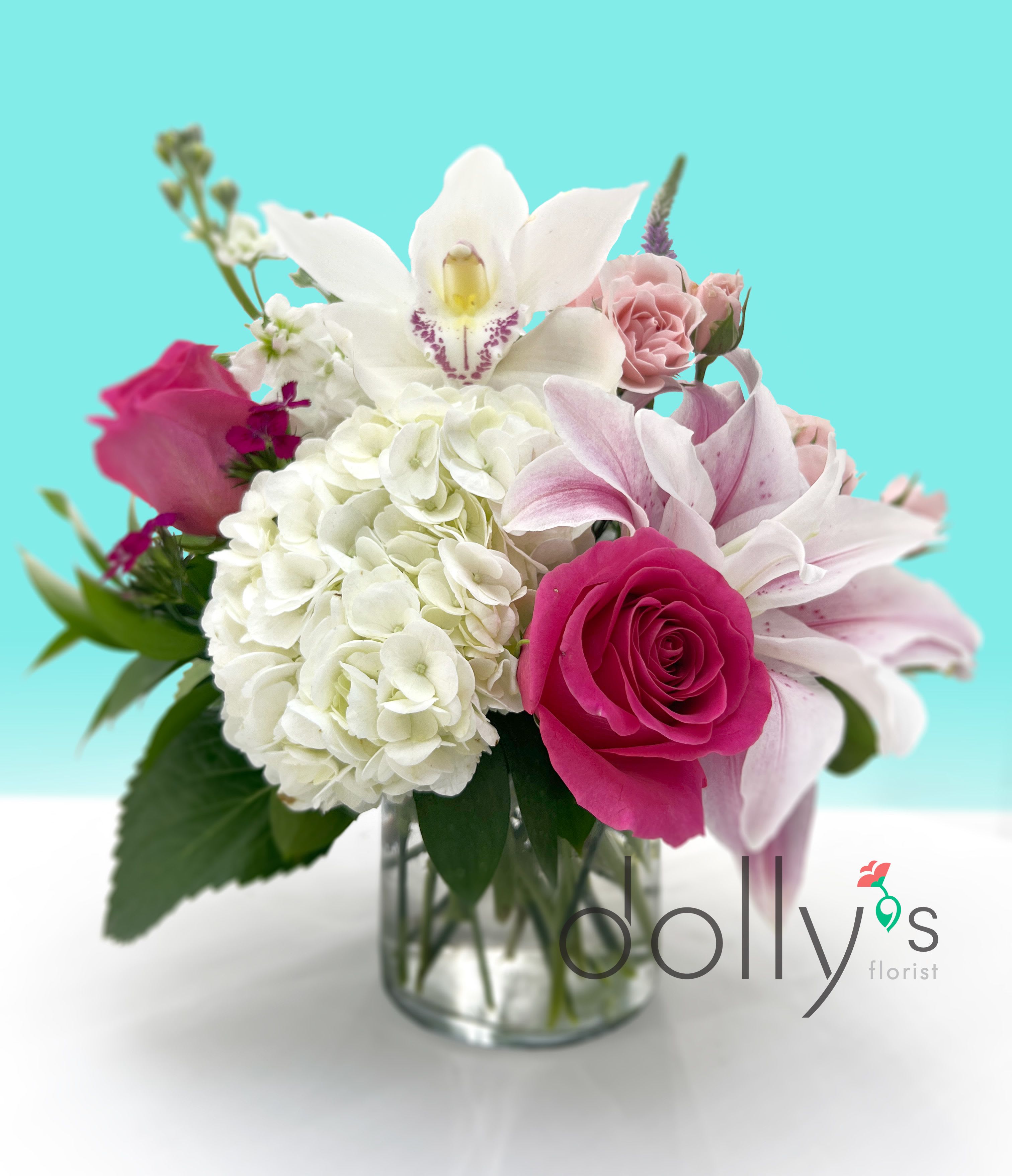Andromeda - Inspired by a princess of myth and a constellation, &quot;Andromeda&quot; exudes regality and femininity. It features stunning lilies, hydrangeas, hot pink roses, and a delicate orchid as a crown.